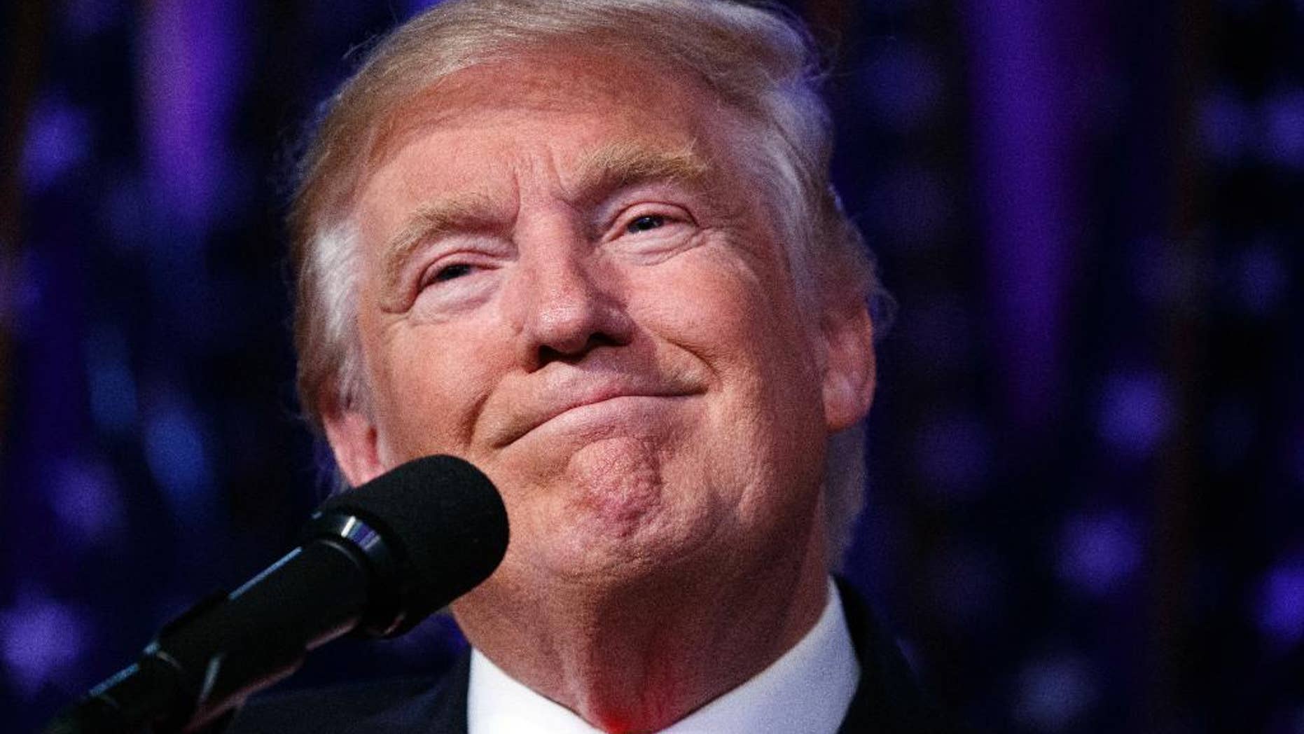 FILE - In this Nov. 9, 2016, file photo, President-elect Donald Trump smiles as he arrives to speak at an election night rally, Wednesday in New York. Donald Trump enters the White House on Jan. 20 just as he entered the race for president: defiant, unfiltered, unbound by tradition and utterly confident in his chosen course. In the 10 weeks since his surprise election as the nation’s 45th president, Trump has violated decades of established diplomatic protocol, sent shockwaves through business boardrooms, tested long-standing ethics rules and continued his combative style of replying to any slight with a personal attack _ on Twitter and in person. (AP Photo/ Evan Vucci, File)
