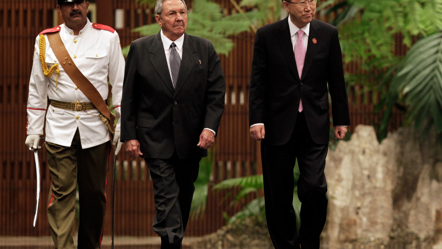 Cuba's President Raul Castro, left center, and U.N. Secretary General Ban Ki-moon, right, review an honor guard at the Revolutionary Palace in Havana, Cuba, Monday, Jan. 27, 2014. (AP Photo/Pool)