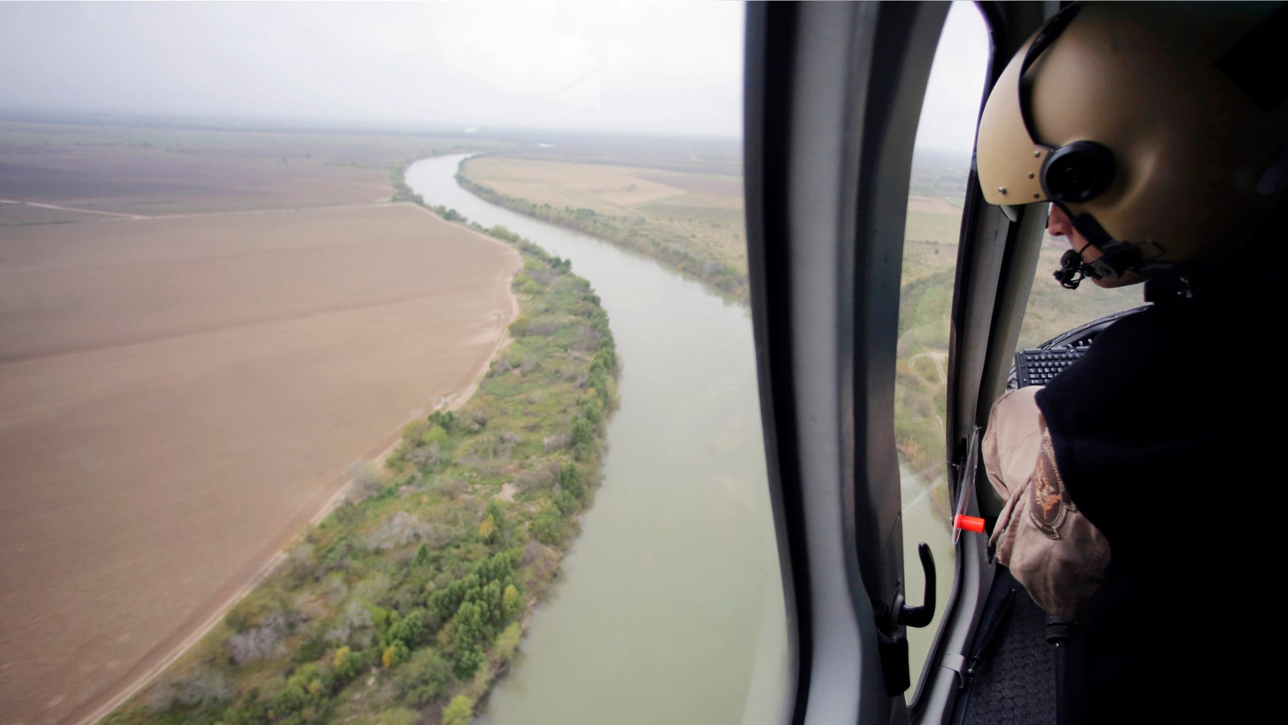 In this Feb. 24, 2015 photo, U.S. Customs and Border Protection Air and Marine agents patrol along the Rio Grande on the Texas-Mexico border near Rio Grande City, Texas. Drowning deaths have spiked since last fall as a surge of law enforcement along the Mexico border prompts immigrants, desperate to avoid detection by a surge of law enforcement, to choose more dangerous and remote crossings into South Texas. (AP Photo/Eric Gay)