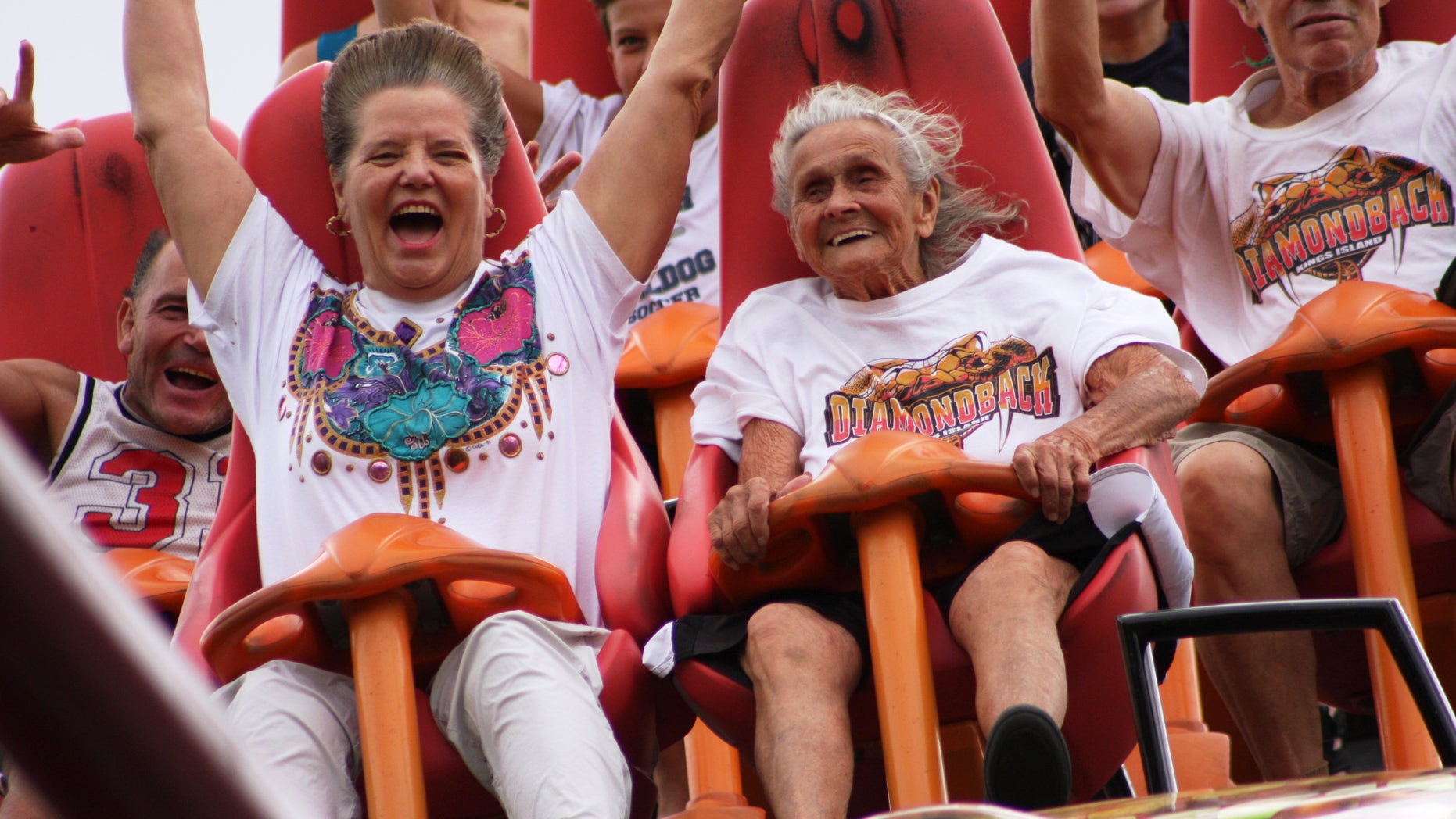 July 13, 2012: In this photo provided by Kings Island, Thelma Gratsch, center, celebrates her 90th birthday by riding her favorite roller coaster, Diamondback, at Kings Island amusement park in Mason, Ohio.