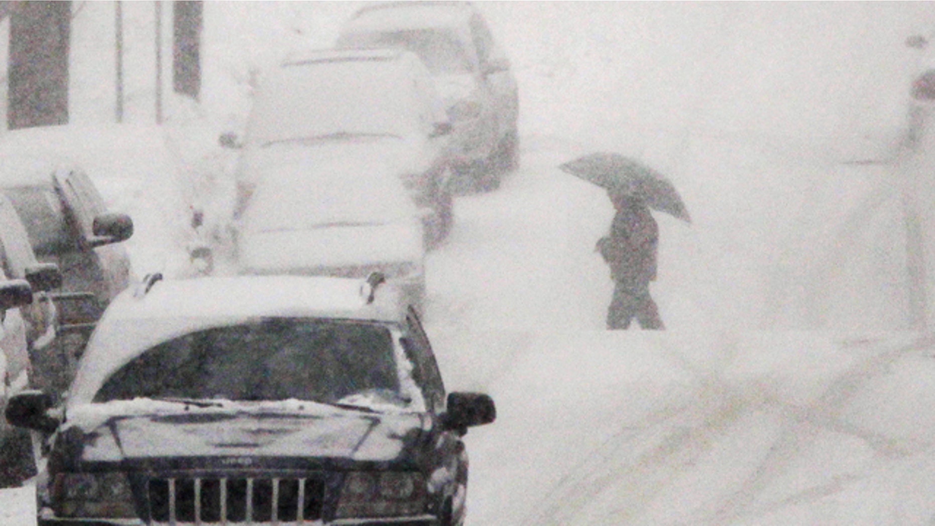 Jan. 26: A person with an umbrella crosses the street as snow falls in Belleville, N.J.