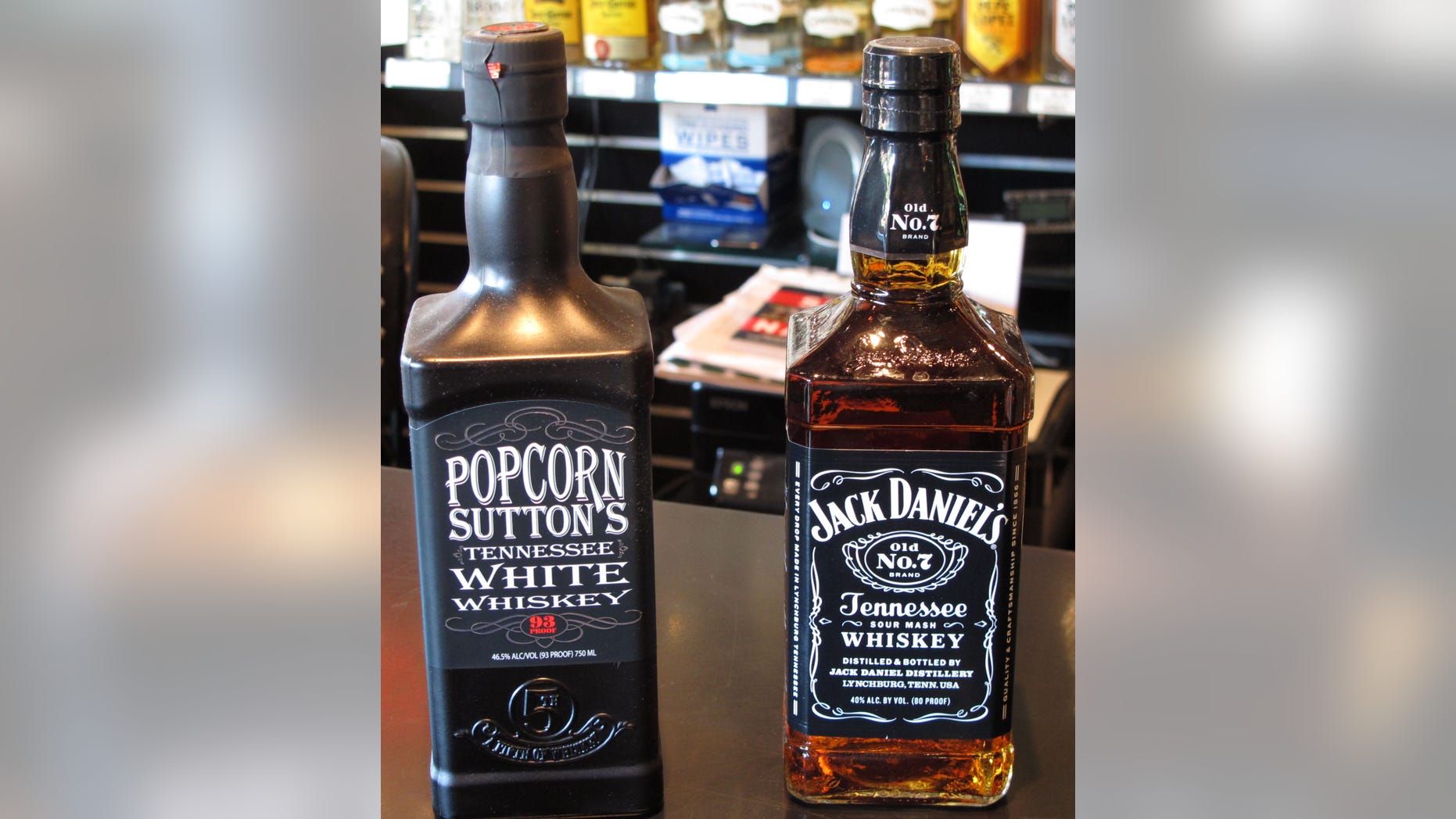 Bottles of Popcorn Suttons Tennessee White Whiskey and Jack Daniels Tennessee whiskey sit side by side at a Louisville, Ky., liquor store.
