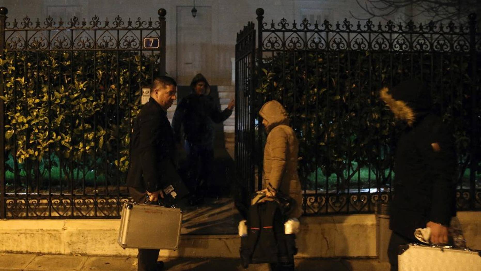 Police investigators enter the house of the Russian consul Andrei Malanin in Athens, Monday, Jan. 9, 2017. Greek police say the Russian consul in Athens has been found dead in his flat in the Greek capital, but there are no immediate indications of foul play.(Costas Baltas/InTime News via AP)