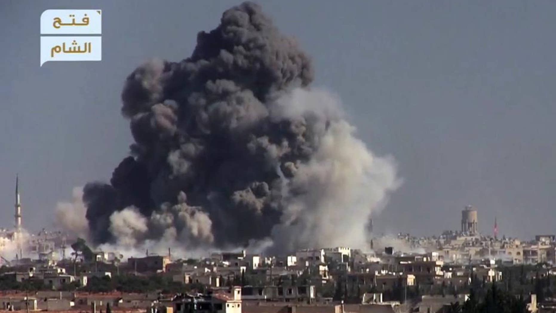 This frame grab from video provided by this militant video by Fatah al-Sham Front that is consistent with independent AP reporting, shows black smoke rises from a suicide bomb attacked Syrian government forces positions, in western Aleppo, Syria, Thursday, Nov. 3, 2016. The Britain-based Syrian Observatory for Human Rights, which monitors the conflict through local contacts, reported that rebels attacked government positions with two explosives-laden vehicles. Syrian rebels launched a fresh wave of attacks on western districts of Aleppo Thursday as airstrikes on a rebel-held village south of the contested city killed civilians, activists said. (militant video by Fatah al-Sham Front, via AP)
