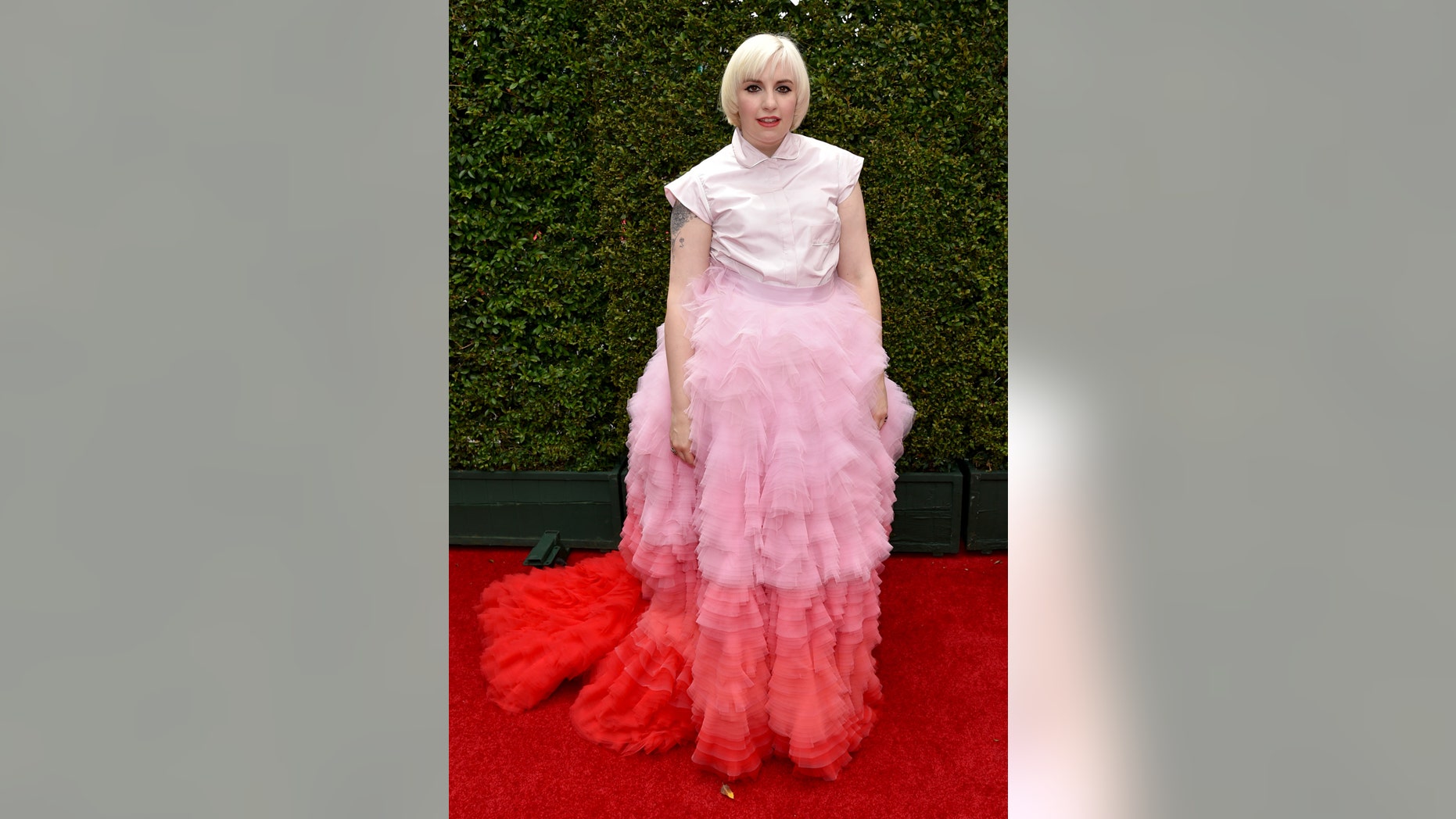 IMAGE DISTRIBUTED FOR THE TELEVISION ACADEMY - Lena Dunham arrives at the 66th Primetime Emmy Awards at the Nokia Theatre L.A. Live on Monday, Aug. 25, 2014, in Los Angeles. (Photo by John Shearer/Invision for the Television Academy/AP Images)