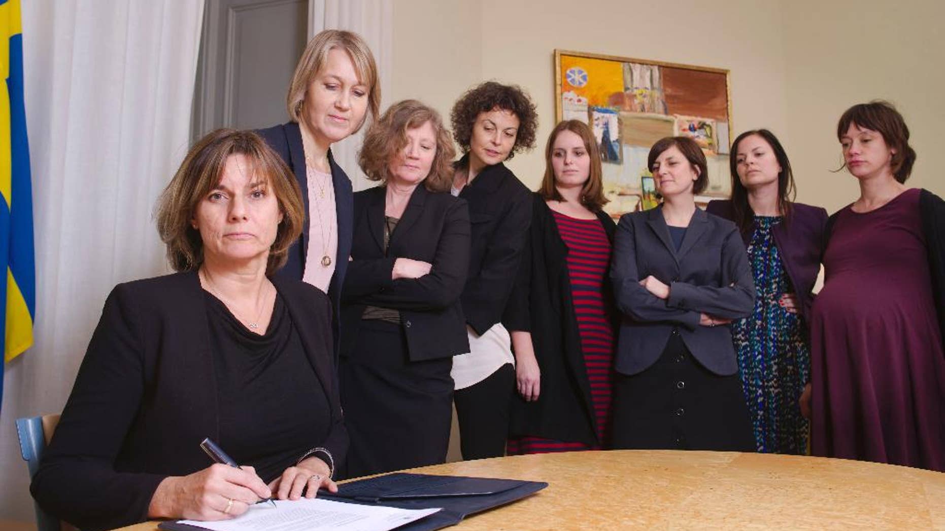In this handout photo provided by the Swedish Government, Sweden's Deputy Prime Minister Isabella Lovin, left, signs a proposal for the Scandinavian country's new climate law in Stockholm, Friday, Feb. 3, 2017. Sweden's Deputy Prime Minister has posted on Facebook an all-woman photo including herself signing a proposal for the Scandinavian country's new climate law - a photo many online commentators have taken as a direct swipe at Donald Trump. (Johan Schiff/Swedish Government via AP)