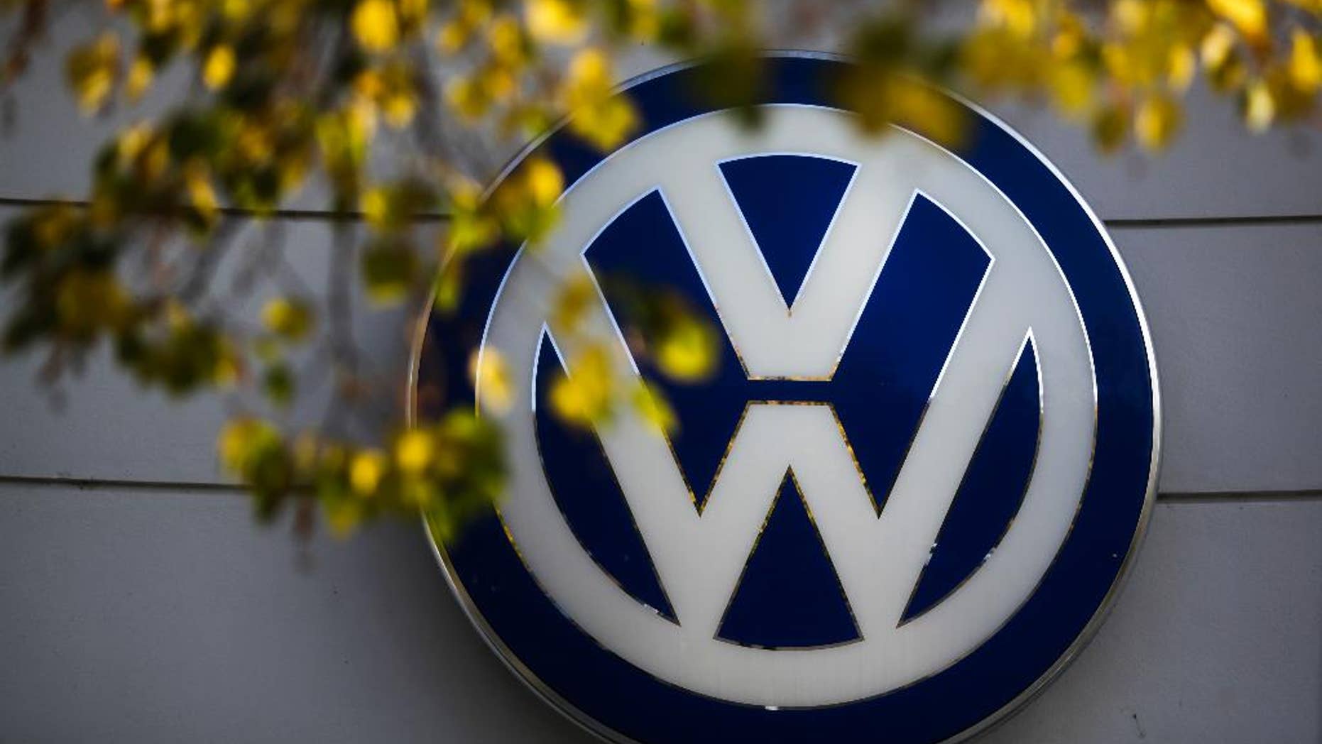 FILE - This Oct. 5, 2015 file photo shows the Volkswagen logo at the building of a company retailer in Berlin, Germany. Volkswagen almost inevitably will have to compensate owners of diesel cars equipped with emissions-rigging software. Some legal experts say the automaker could be forced to buy back the cars altogether. (AP Photo/Markus Schreiber, File)