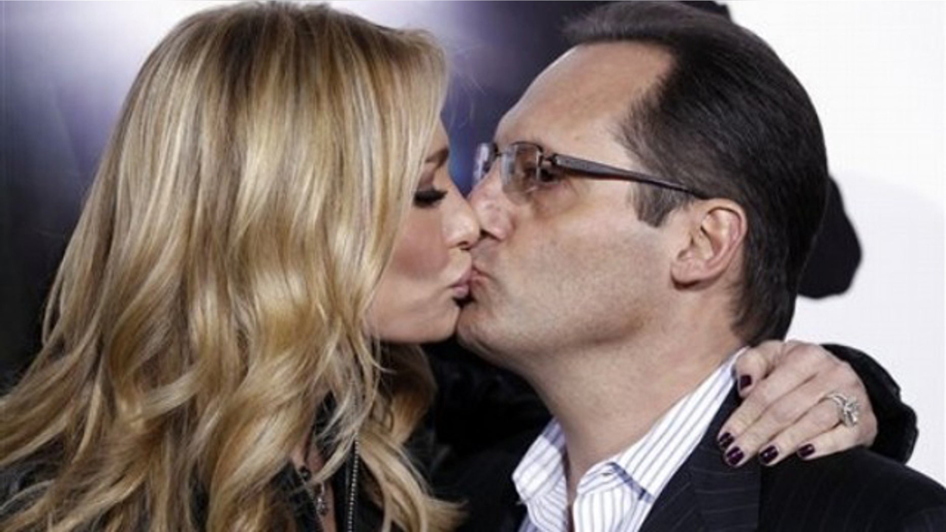 Reality television personalities Taylor, left, and Russell Armstrong kiss as they arrive at the premiere "The Green Hornet" in Los Angeles, on Monday, Jan 10, 2011. (AP Photo/Matt Sayles)