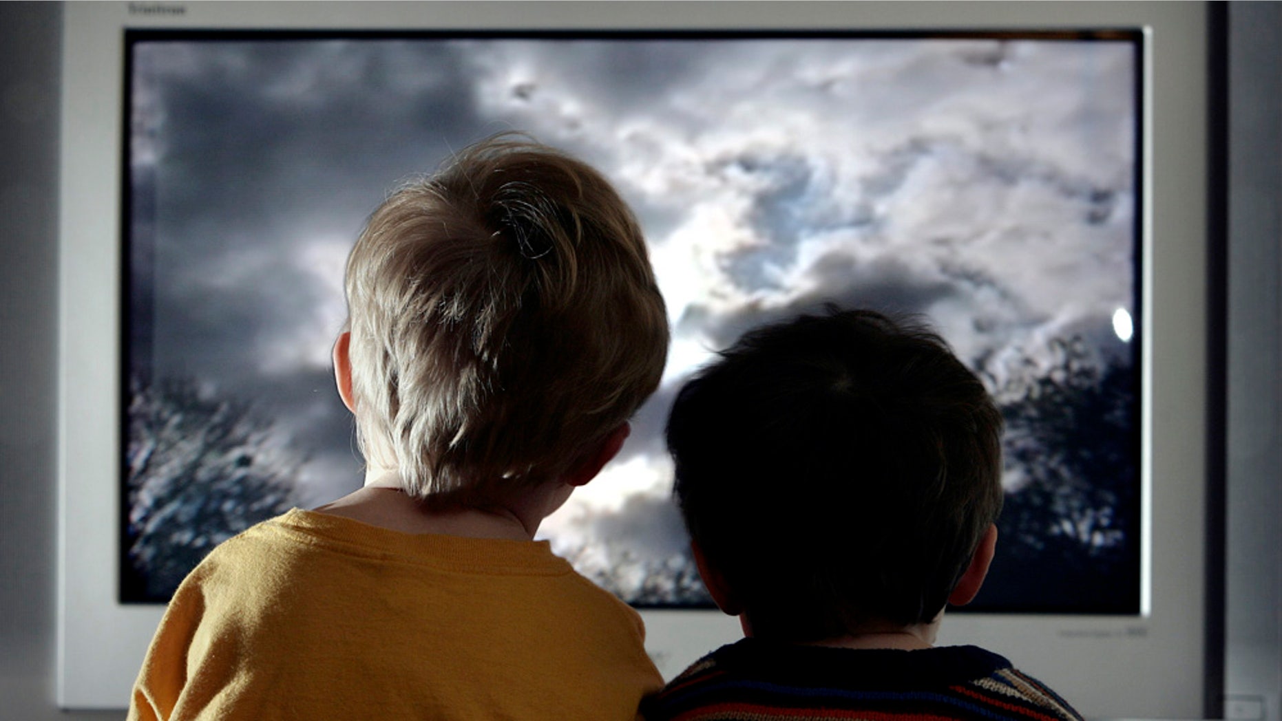 LONDON - JANUARY 27: In this photo illustration two young child watch television at home, January 27, 2005 in London, England. (Photo Illustration by Peter Macdiarmid/Getty Images)