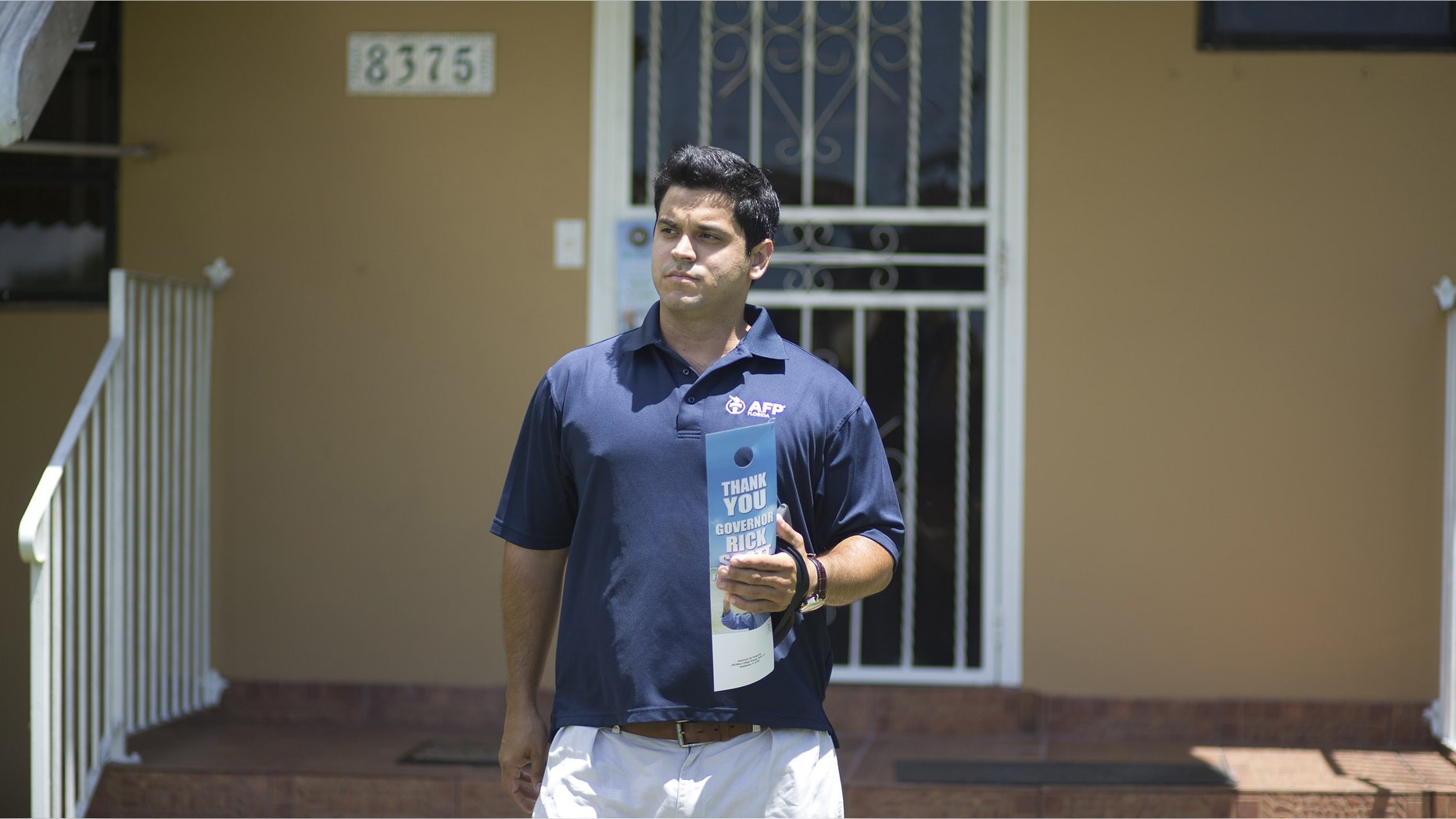In this Aug. 12, 2014 photo, Andres Malave walks the street of a west Miami neighborhood. He started the day huddled with about a dozen volunteers in a Cuban restaurant here, offering them a last-minute pep talk before they went out to meet with voters. Itâs a strategy playing out in New England diners, Midwest truck stops and West Coast cafes: coordinators for Americans for Prosperity conservative organizers train and send out volunteers armed with an iPad and an interest in helping fellow activists shift Americaâs politics in their direction. These volunteers ground troops make up the backbone of Americans for Prosperity, the flagship organization of the political network overseen by industrialist billionaires Charles G. and David H. Koch. (AP Photo/J Pat Carter)
