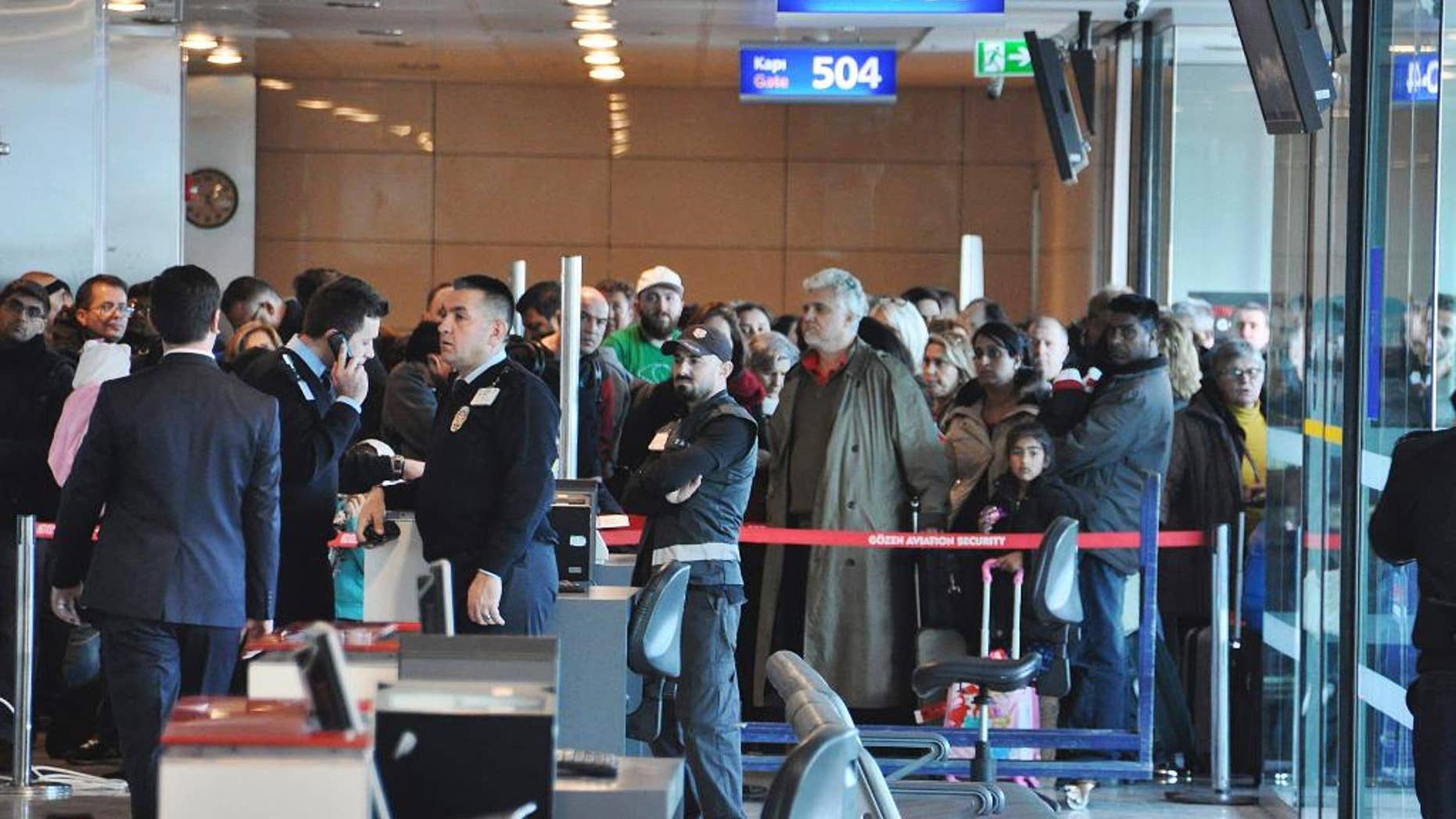 Passengers of a Turkish Airlines flight to Toronto, Canada, wait at the boarding gate in Istanbul's Ataturk international airport, Saturday, Feb. 18, 2017. A Turkish Airlines plane in Istanbul was evacuated Saturday after a suspicious note was discovered in one of its bathrooms. The Turkish Airlines cabin crew found the words "BOMB TO TORONTO" on the bathroom's wall on Flight TK-17 during its pushback from the gate, a Turkish Airlines press official told The Associated Press. (DHA-Depo Photos via AP)