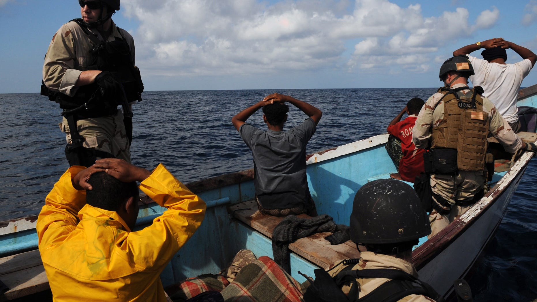 GULF OF ADEN - OCTOBER 15: In this photo provided by the U.S. Navy, Members of a visit, board, search and seizure team from the guided-missile cruiser USS Anzio (CG 68) and U.S. Coast Guard Maritime Safety and Security Team 91104 secure the crewmembers of a drug smuggling vessel October 15, 2009 in the Gulf of Aden. Anzio is the flagship of Combined Joint Task Force 151, a multinational task force established to conduct counter-piracy operations off the coast of Somalia. (Photo by Matthew Bash/U.S. Navy via Getty Images)