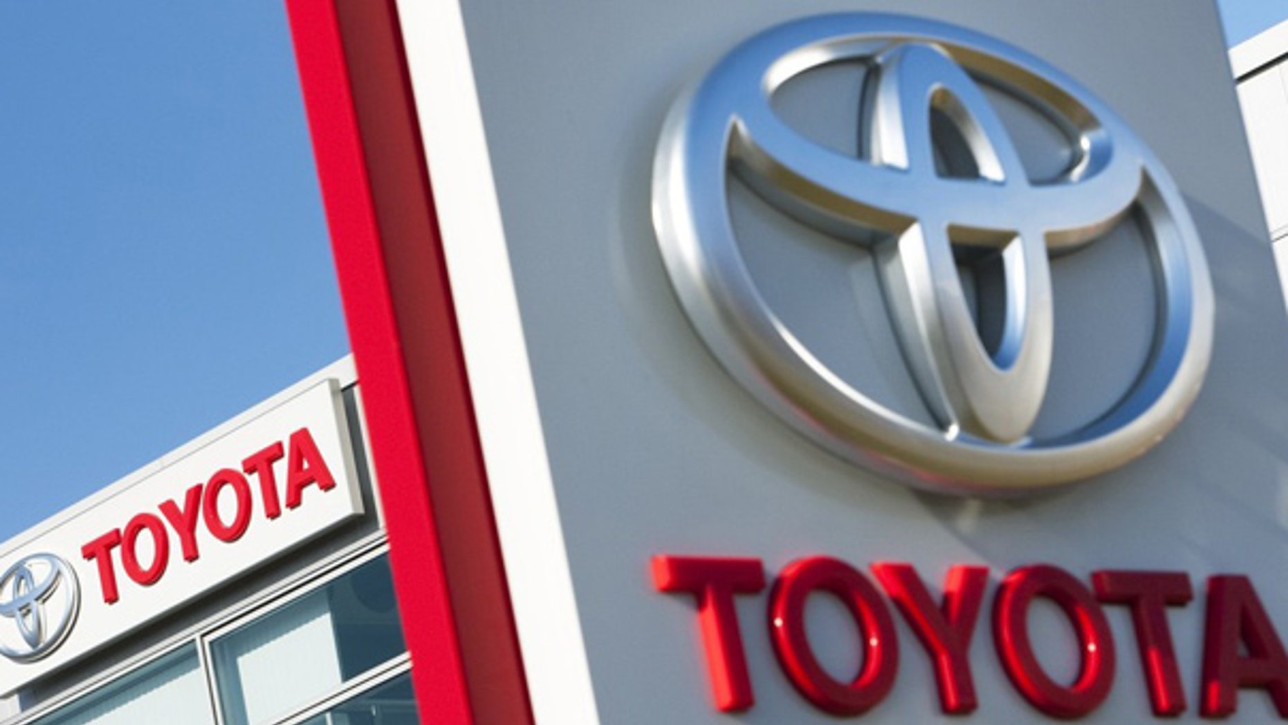 Toyota logos are pictured at a dealership.