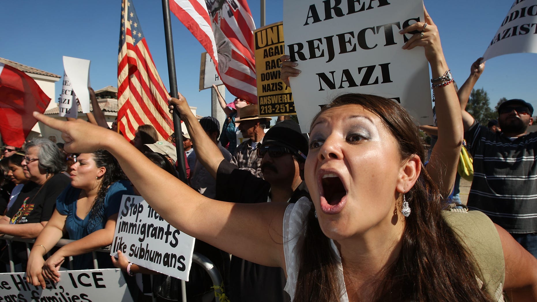 RIVERSIDE, CA - OCTOBER 24: Counter-protester Erika Paz yells at members of the white supremacist group, the National Socialist Movement, during the NSMÕs anti-illegal immigration rally near a Home Depot store on October 24, 2009 in Riverside, California. It is the second such demonstration in Riverside by the Detroit-based Neo-Nazi group in the past month. The last rally was soon broken up by police after clashes with counter-protesters. (Photo by David McNew/Getty Images)