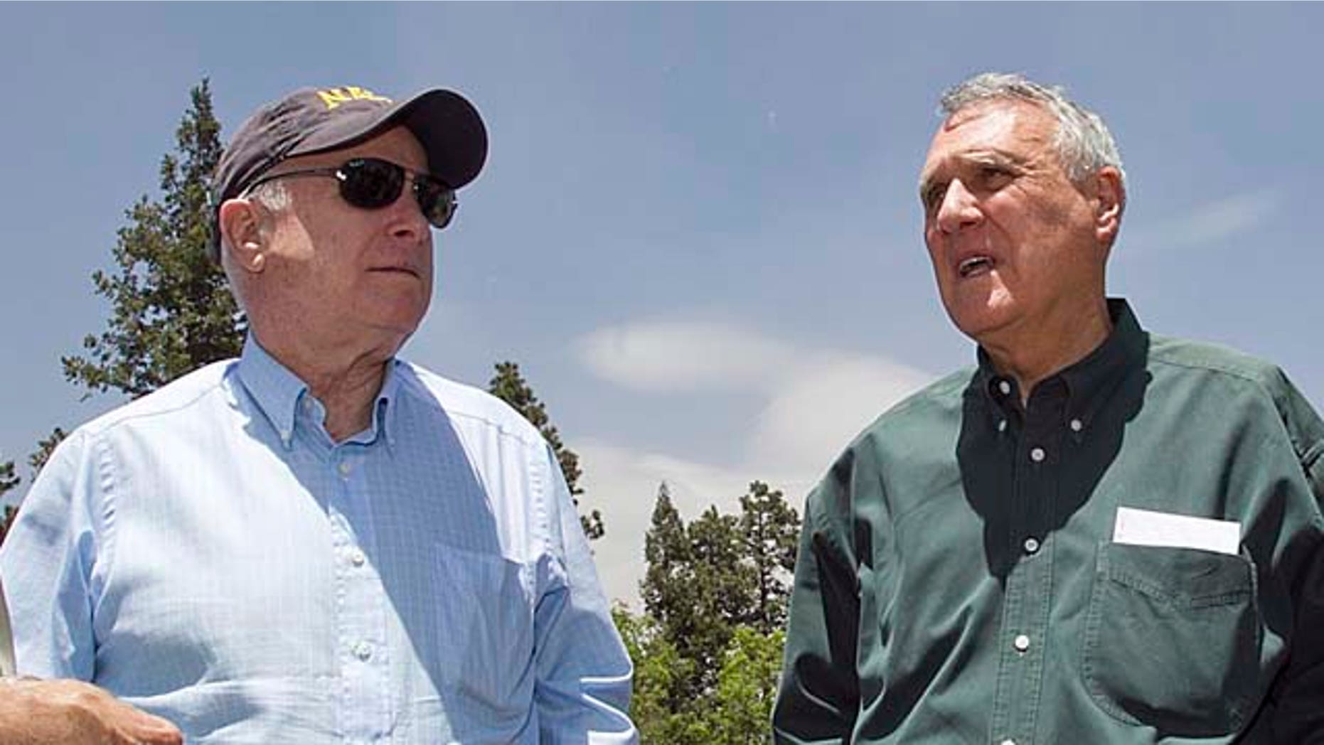 Sen. John McCain, right, with Sen. Jon Kyl in the forest surrounding Alpine, Ariz. Saturday, June 18, 2011 during a tour of the burned areas of the Wallow Fire. The fire has burned more than 500,000 acres in eastern Arizona. (AP Photo/The Arizona Republic, Tom Tingle) MARICOPA COUNTY OUT; MAGS OUT; NO SALES