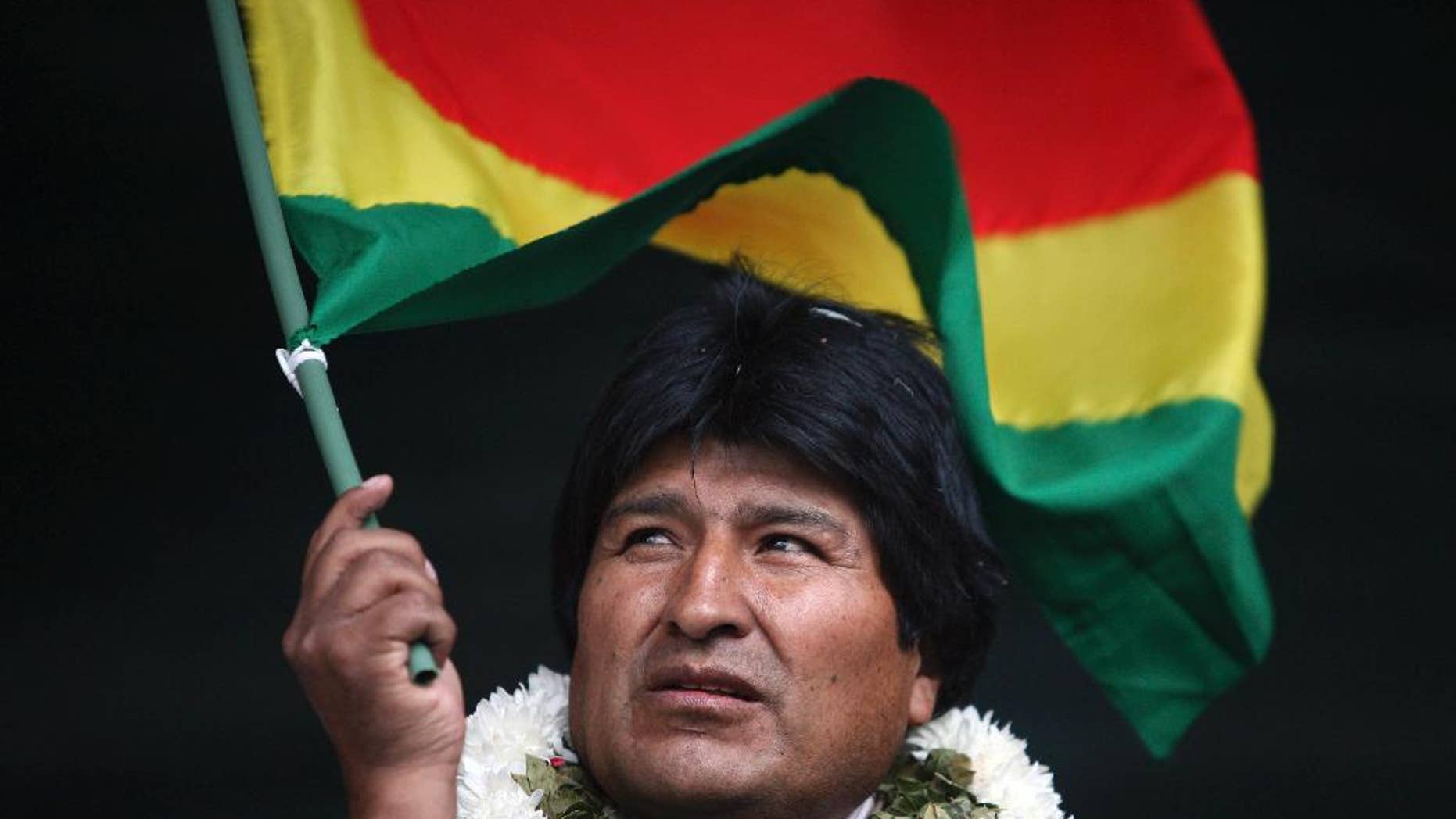 FILE - In this Jan. 22, 2009 file photo, Bolivia's President Evo Morales waves a Bolivian flag during a rally in support of the proposed new constitution in Cochabamba, Bolivia. Morales inaugurated a $7 million museum on Feb. 2, 2017 in his native village of Orinoca, coined the Museum of the Democratic and Cultural Revolution. Bolivia’s political opposition has dubbed it the "Evo Museum." (AP Photo/Dado Galdieri, File)