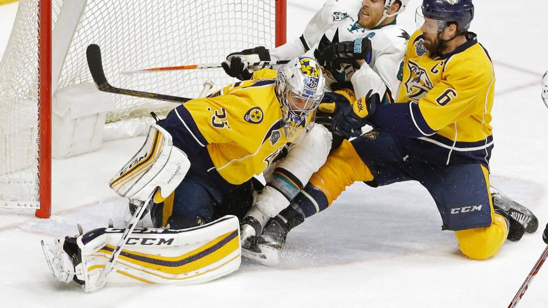 San Jose Sharks center Joe Pavelski (8) and Nashville Predators defenseman Shea Weber (6) slide into Predators goalie Pekka Rinne (35), of Finland, during the second overtime period in Game 4 of an NHL hockey Stanley Cup Western Conference semifinal playoff series Friday, May 6, 2016, in Nashville, Tenn. (AP Photo/Mark Humphrey)