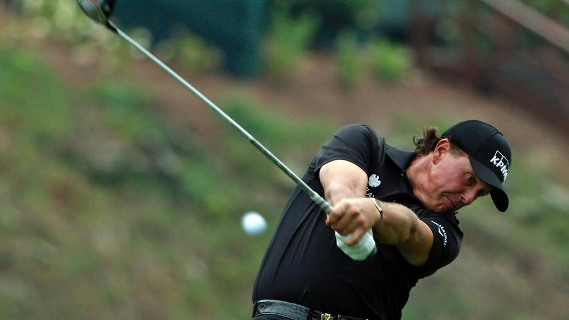 Phil Mickelson hits his tee shot on the 15th hole during the second round of the PGA Championship golf tournament at Valhalla Golf Club on Friday, Aug. 8, 2014, in Louisville, Ky. (AP Photo/Mike Groll)