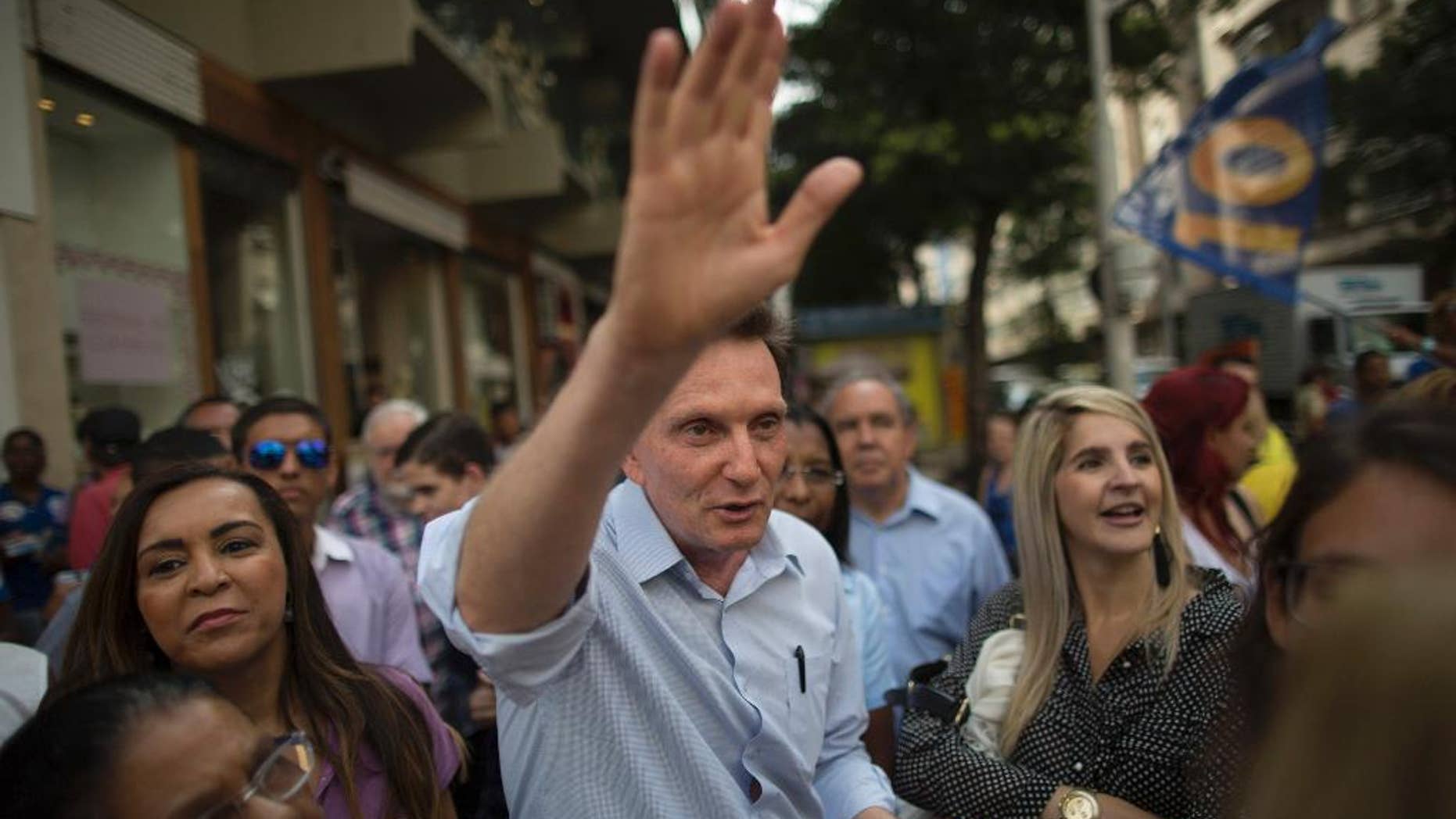 FILE - In this Sept. 29, 2014 file photo, Marcelo Crivella, bishop of the Universal Church of the Kingdom of God, campaigns for governor of Rio de Janeiro state, for the Brazilian Republican Party, in Copacabana, Rio de Janeiro, Brazil. Crivella has beaten his opponent in a landslide victory on Sunday, Oct. 30, to become Rio de Janeiro’s mayor, signaling a move toward the right in Latin America’s largest nation (AP Photo/Leo Correa, File)
