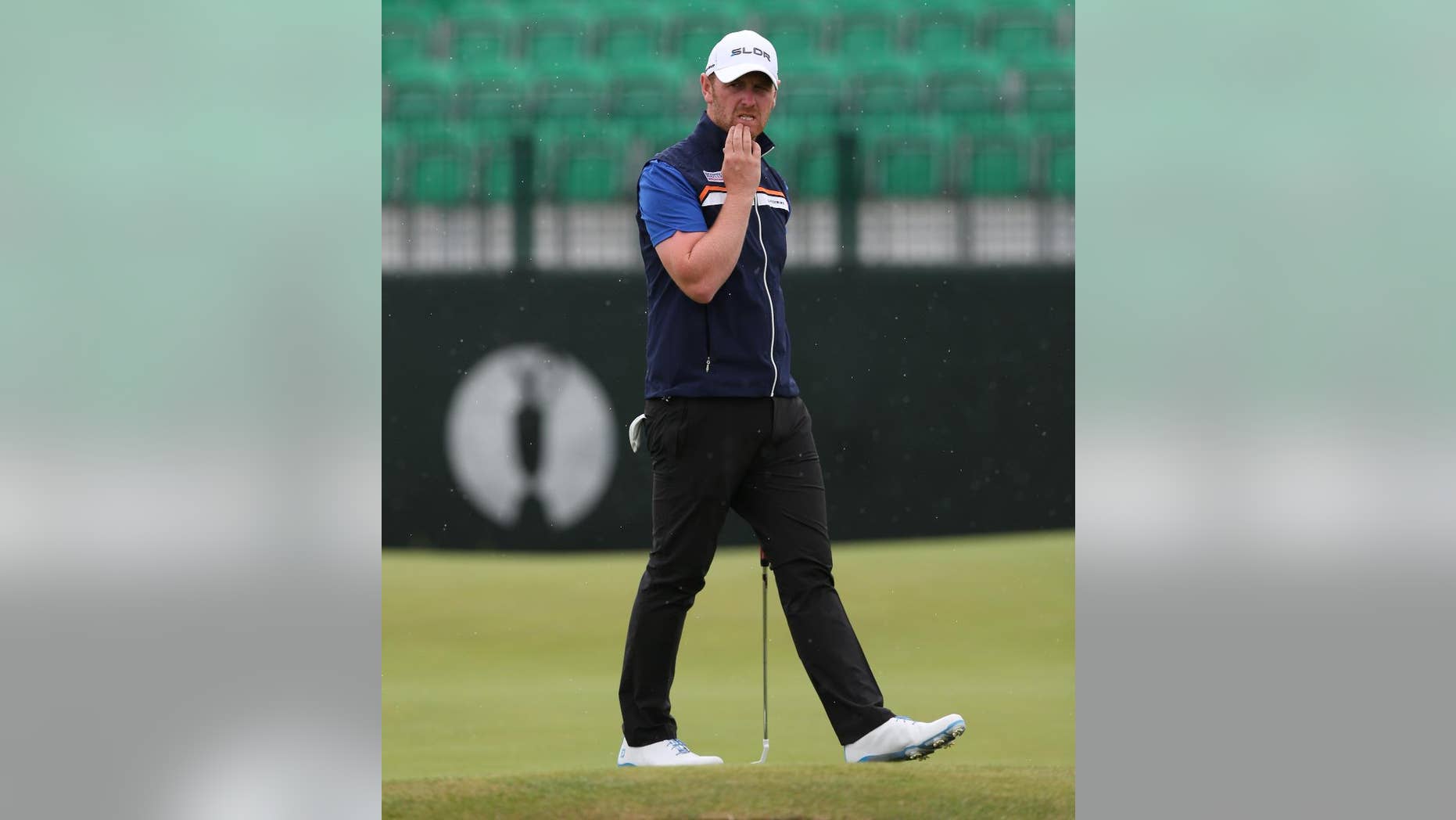 John Singleton of England looks at his ball on the 3rd green during a practice round ahead of the British Open Golf championship at the Royal Liverpool golf club, Hoylake, England, Wednesday July 16, 2014. The British Open Golf championship starts Thursday July 17. (AP Photo/Jon Super)