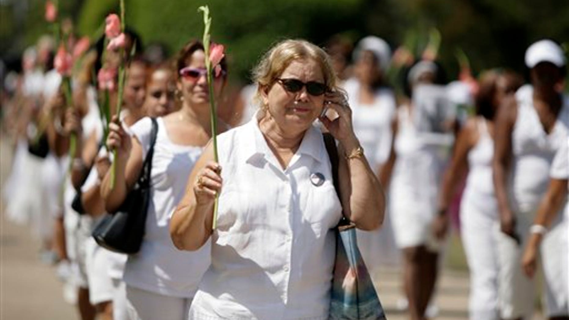 The late Laura Pollan (above, speaking on a cell phone) was leader and a founder of the dissident group Ladies in White, which held weekly marches in Havana to call for the release of political prisoners. Ladies in White included many mothers, wives and daughters of political prisoners.