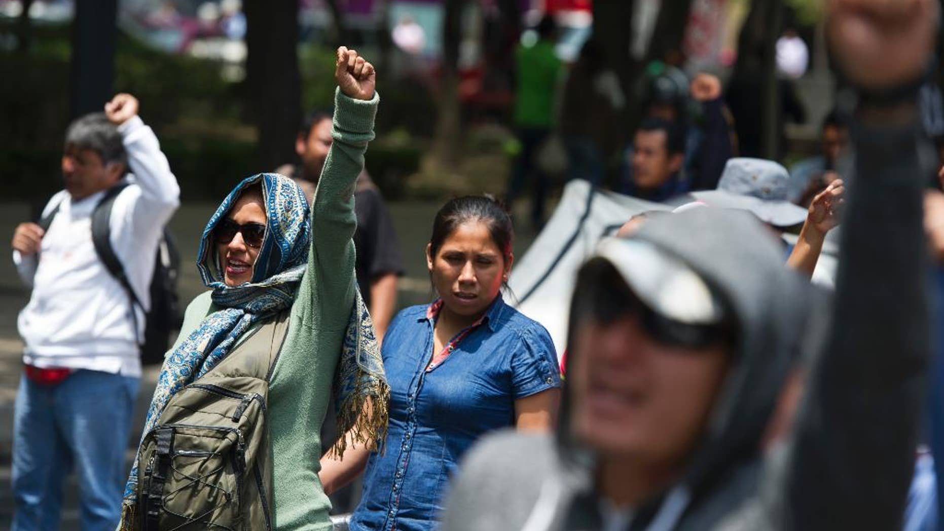 Protestors with the CNTE teachers union demonstrate along Paseo de la Reforma in Mexico City, Monday, June 13, 2016. The teachers union is striking against plans to overhaul the country's education system which include federally mandated teacher evaluations. (AP Photo/Nick Wagner)