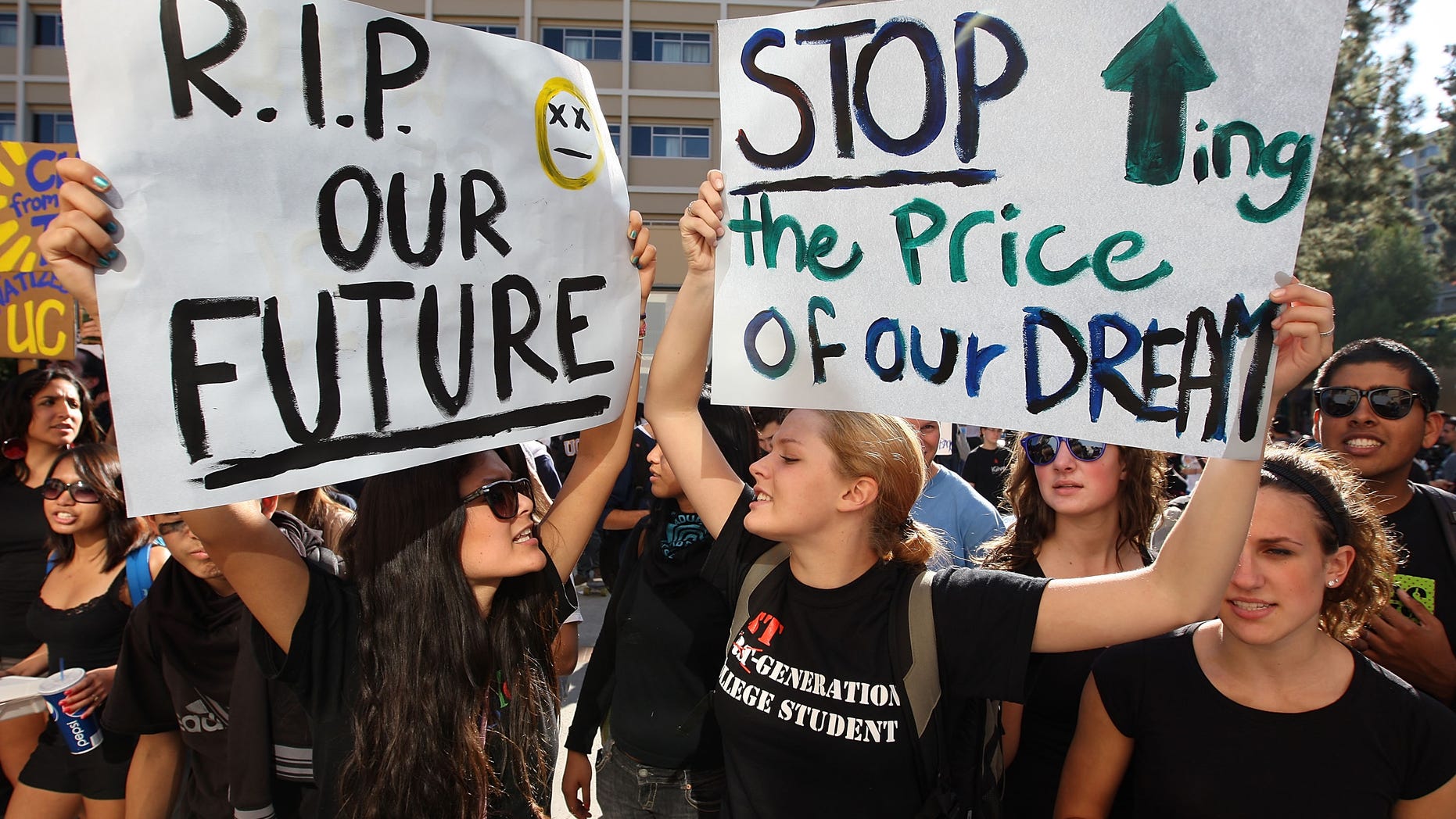 LOS ANGELES, CA - NOVEMBER 19: University of California Los Angeles (UCLA) students Andrea Flores (L) and Kendall Brown (R) and other UCLA students and supporters demonstrate outside the UC Board of Regents meeting where members voted to approve a 32 percent tuition hike next year on November 19, 2009 in Los Angeles, California. Undergraduate fees for students at the California university system would be increasing by about $2,500. It is the second day that demonstrators, including students from other UC campuses, have gathered to try to dissuade the board from approving the proposed increase. Massive cuts to balance the state budget have squeezed education funds in California. (Photo by David McNew/Getty Images)