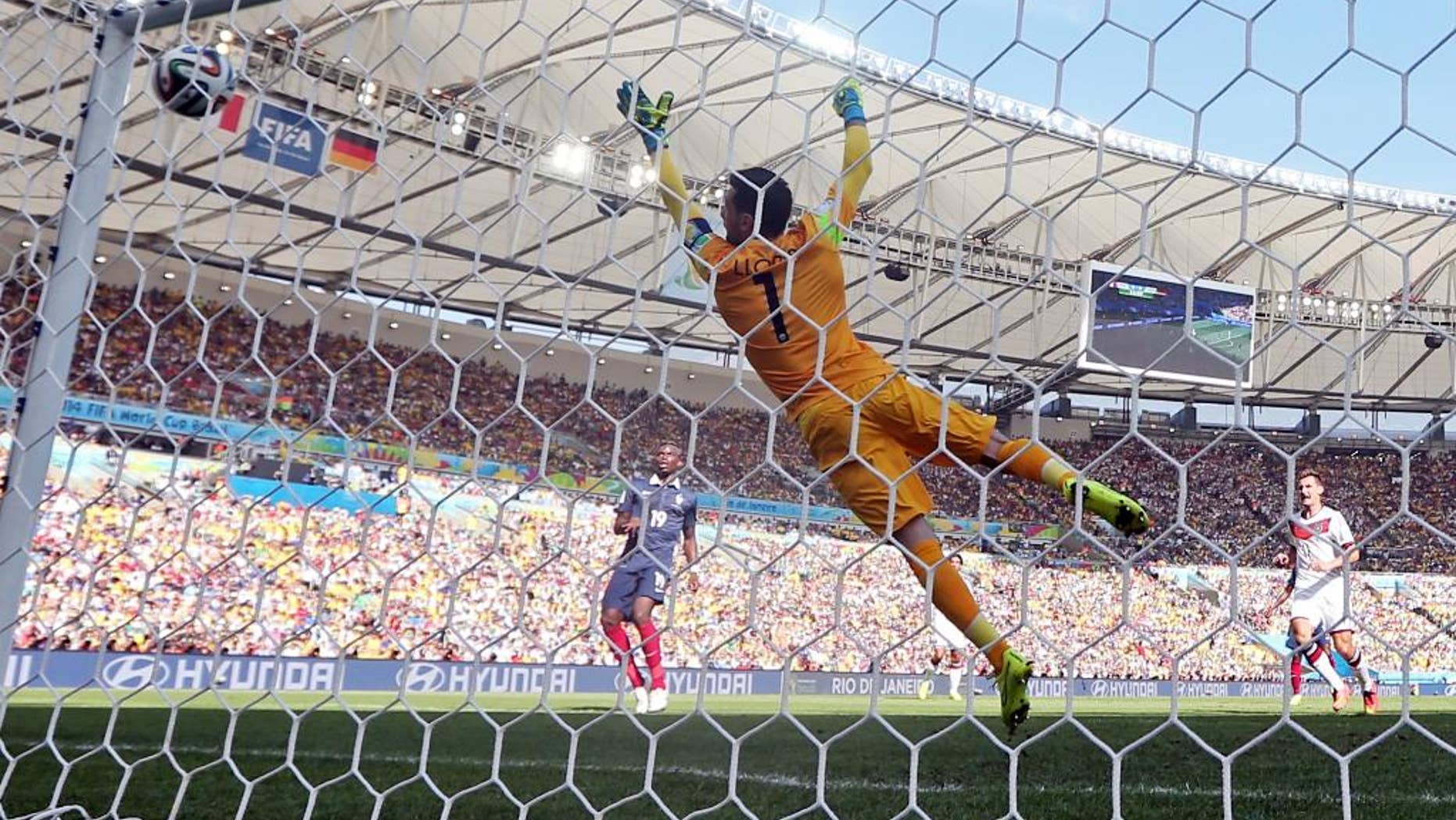 France's goalkeeper Hugo Lloris fails to stop a shot by Germany's Mats Hummels as he scored his side's first goal during the World Cup quarterfinal soccer match between Germany and France at the Maracana Stadium in Rio de Janeiro, Brazil, Friday, July 4, 2014. (AP Photo/Matthias Schrader)