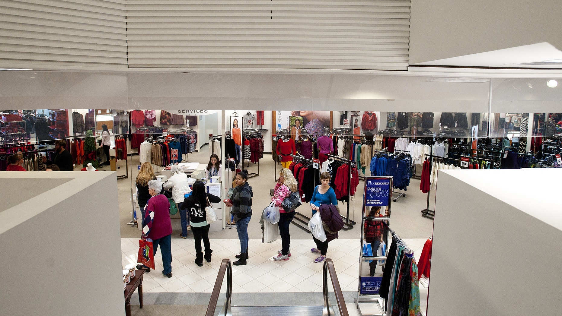 FILE -In this Thursday, Dec. 26, 2013, file photo, people wait in line to at a customer service desk while shopping the day after Christmas, in Lynchburg, Va. The Federal Reserve reports on consumer borrowing in December on Friday, Feb. 7, 2014. (AP Photo/The News & Advance, Sam O'Keefe, File)