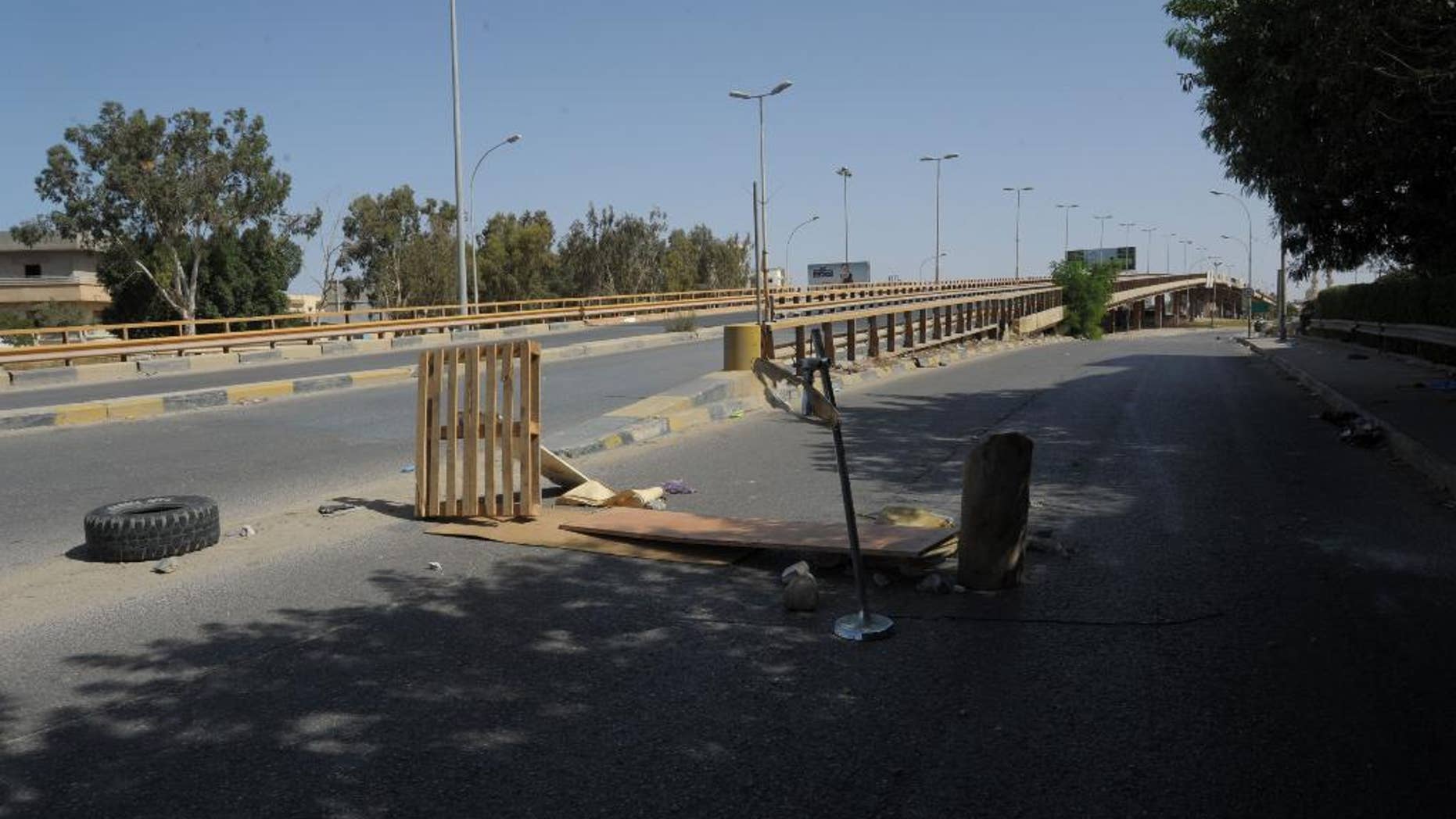 The streets remain empty as fighting raged between Islamist militias and forces loyal to Libya's elected government in Benghazi, Libya on Friday, Oct. 17, 2014. The latest cycle of violence follows more than two years of dashed hopes and failed attempts by civilians to stand up to the Islamist militias. Activists, judges, journalists, policemen and army officers have been gunned down in a series of assassinations carried out by assailants who have not been caught. As the central government flounders, hard-line Islamists act with impunity. (AP Photo/Mohammed Elsheiky)