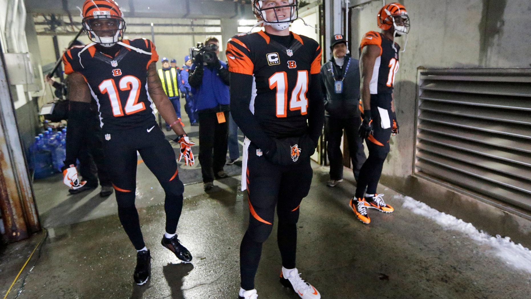 FILE - In this Sunday, Jan. 5, 2014, file phot, Cincinnati Bengals quarterback Andy Dalton (14) waits to take the field for an NFL wild-card playoff football game against the San Diego Chargers in Cincinnati. The Bengals are expressing support for the third-year quarterback after yet another poor showing in the playoffs, they'll soon have to decide whether he's capable of taking them any farther than the first round (AP Photo/Al Behrman, File)