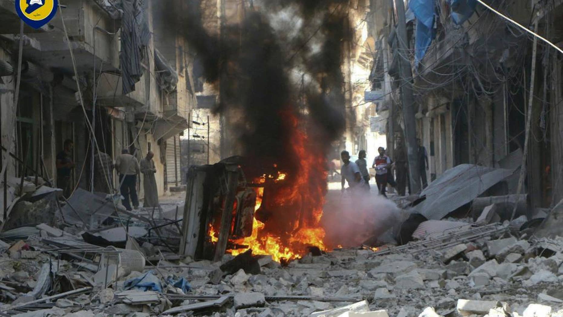 In this photo provided by the Syrian Civil Defense group known as the White Helmets, Syrians inspect damaged buildings after airstrikes by government helicopters on the rebel-held Aleppo neighborhood of Mashhad, Syria, Tuesday Sept. 27, 2016. With diplomacy in tatters and a month left to go before U.S. elections, the Syrian government and its Russian allies are using the time to try and recapture the northern city of Aleppo, mobilizing pro-government militias in the Old City and pressing ahead with the most destructive aerial campaign of the past five years. (Syrian Civil Defense White Helmets via AP)