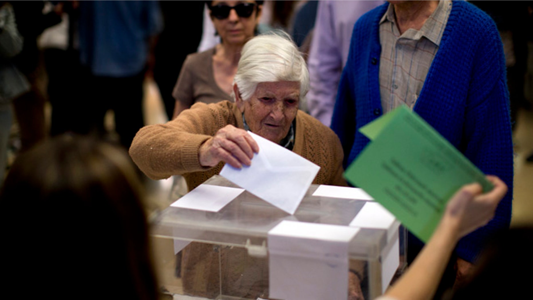 Natividad, 97, casts her vote at a polling station in Barcelona, Spain, Sunday, May 24, 2015. Voters began casting their ballots across much of Spain early Sunday in local elections that could see two upstart parties end ntarly four decades of dominance by the conservative Popular Party and the center-left Socialists. (AP Photo/Emilio Morenatti)