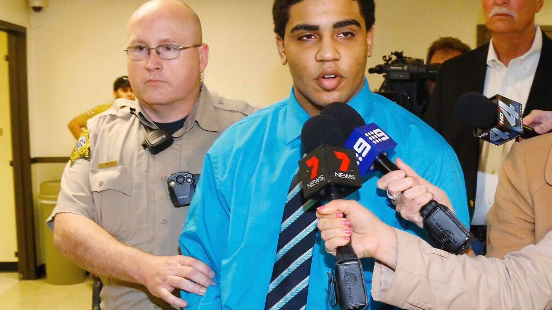 FILE - In this April 17, 2015 file photo, Chancey Luna answers a question for the media as he is led from the courthouse to the jail after being convicted in the death of Christopher Lane in Duncan, Okla. An Oklahoma appeals court on Friday, Dec. 2, 2016, ordered a new sentencing for Luna who has been serving a life in prison without parole term for the fatal shooting of Lane, an Australian baseball player three years ago. (AP Photo/Sue Ogrocki File)