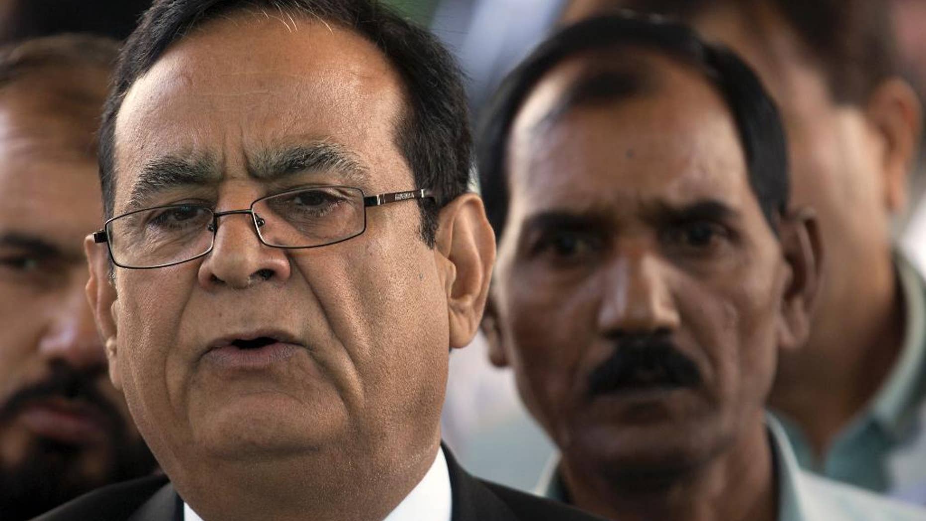 Saiful Malook, left, lawyer of Pakistani Christian woman Aasia Bibi briefs media with Bibi's husband Ashiq Masih outside the Supreme Court in Islamabad, Pakistan. Thursday, Oct. 13, 2016. Pakistan's supreme court has adjourned an appeal from a Christian woman Aasia Bibi who has been on death row on blasphemous charges since 2010 after one of the judges refused to hear the case citing a possible conflict of interest. (AP Photo/B.K. Bangash)