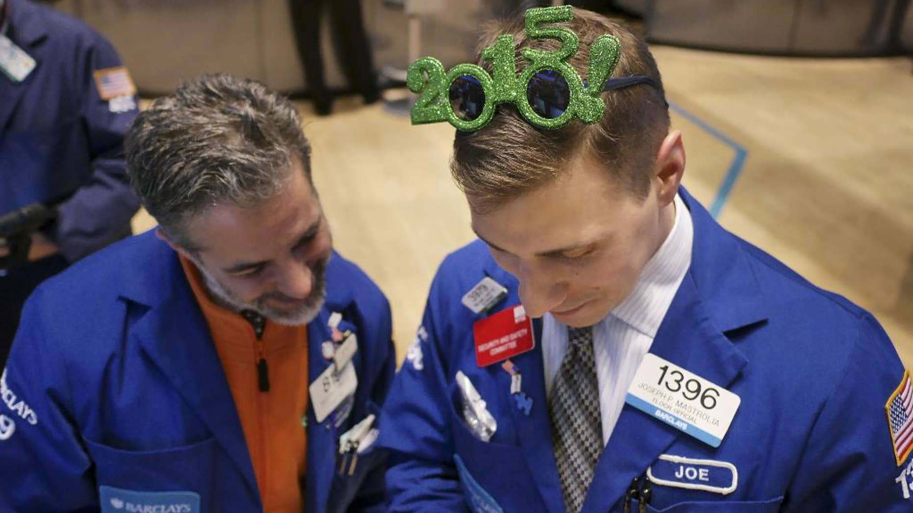 Traders work on the floor at the New York Stock Exchange in New York, Wednesday, Dec. 31, 2014. (AP Photo/Seth Wenig)