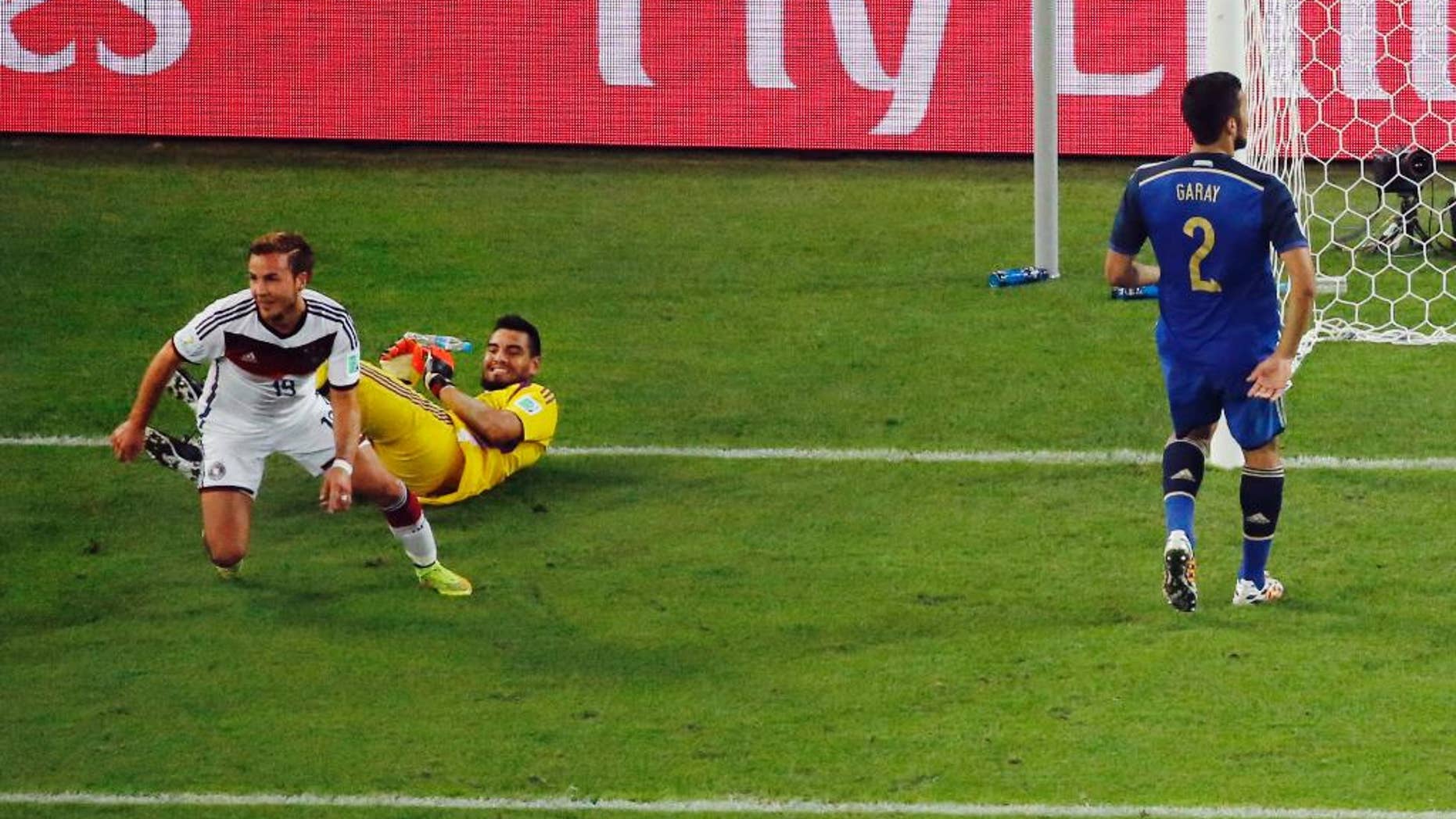 Germany's Mario Goetze celebrates past Argentina's goalkeeper Sergio Romero after scoring his side's first goal during the World Cup final soccer match between Germany and Argentina at the Maracana Stadium in Rio de Janeiro, Brazil, Sunday, July 13, 2014. (AP Photo/Fabrizio Bensch, Pool)
