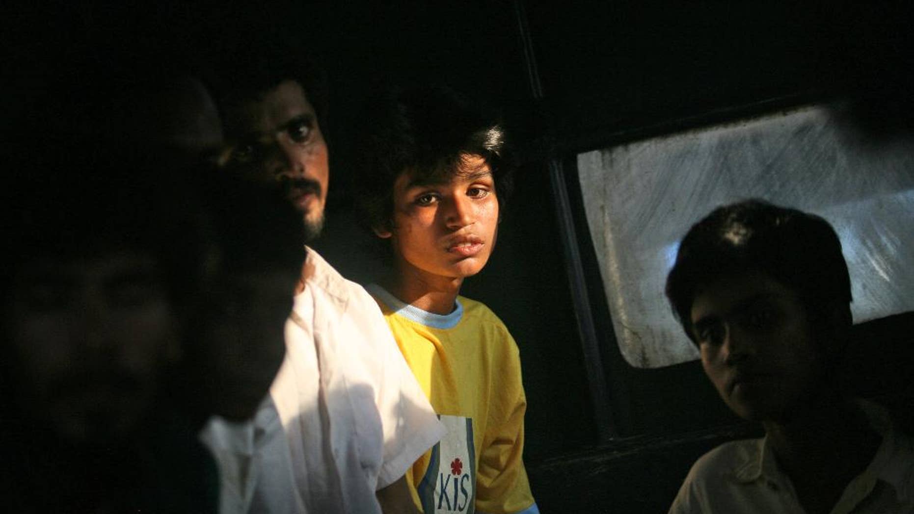 Newly arrived migrants sit inside a bus that will take them to a temporary shelter, in Simpang Tiga, Aceh province, Indonesia, Wednesday, May 20, 2015. In a major diplomatic breakthrough that could ease Southeast Asia's migrant crisis, Indonesia and Malaysia offered Wednesday to temporarily take in thousands of people who have been stranded at sea but appealed for international help, saying the crisis is a global, not regional, problem. (AP Photo/Binsar Bakkara)