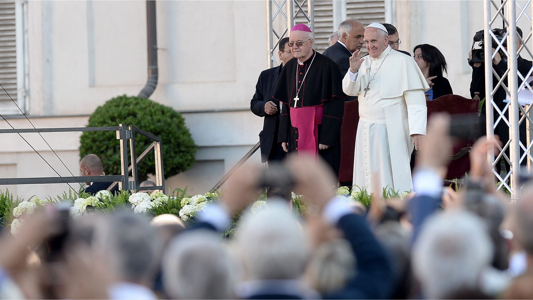 Pope Francis Pope Francis waves during as he meets with workers and businessmen during his visit to Turin, northern Italy, Sunday, June 21, 2015. Pope Francis earlier prayed in front of the Holy Shroud, the 14 foot-long linen revered by some as the burial cloth of Jesus, on display at the Cathedral of Turin. (AP Photo/Massimo Pinca)