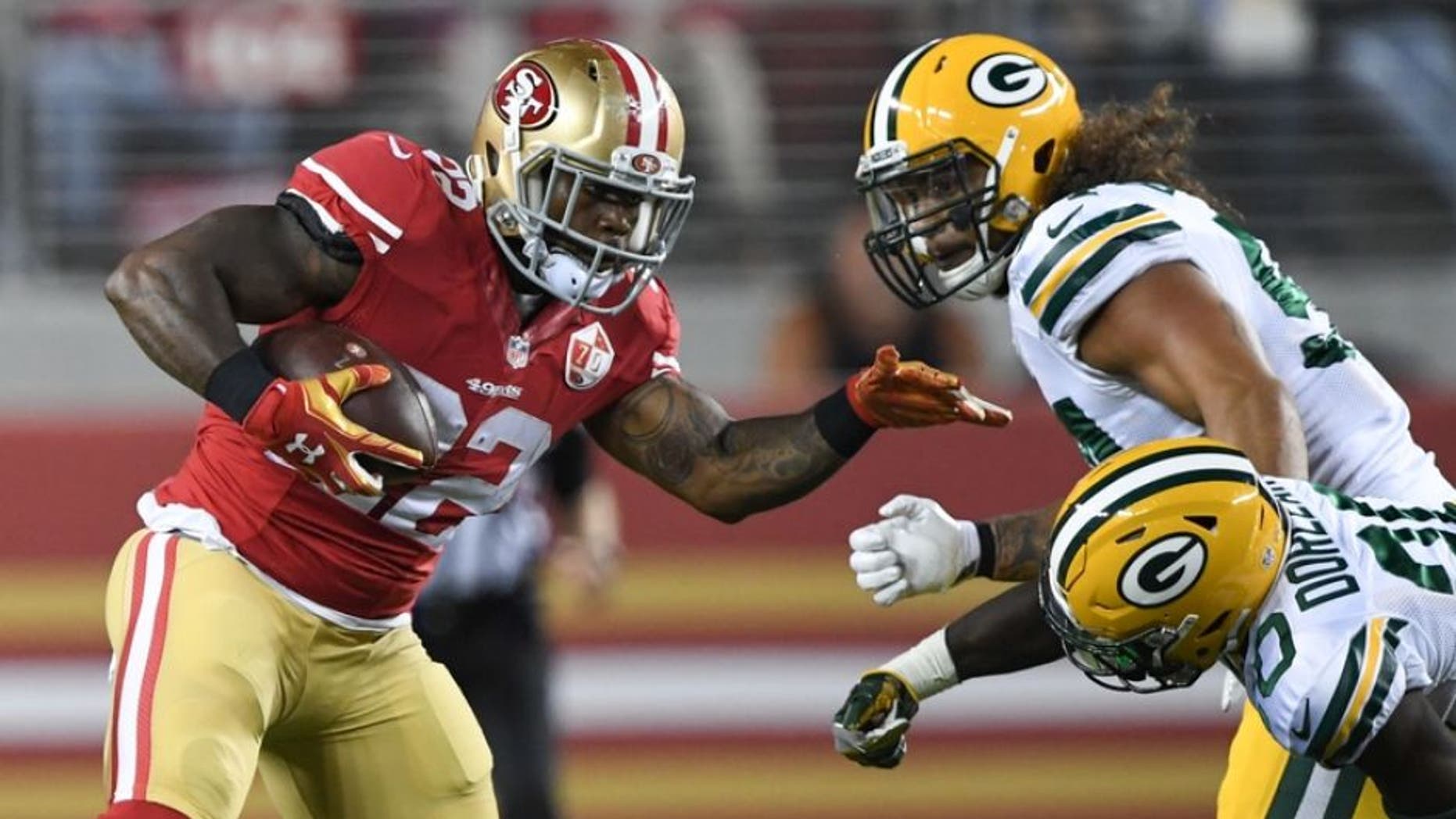 August 26, 2016; Santa Clara, CA, USA; San Francisco 49ers running back Mike Davis (22, left) runs the football against Green Bay Packers defensive back Makinton Dorleant (20) during the third quarter at Levi's Stadium. Mandatory Credit: Kyle Terada-USA TODAY Sports