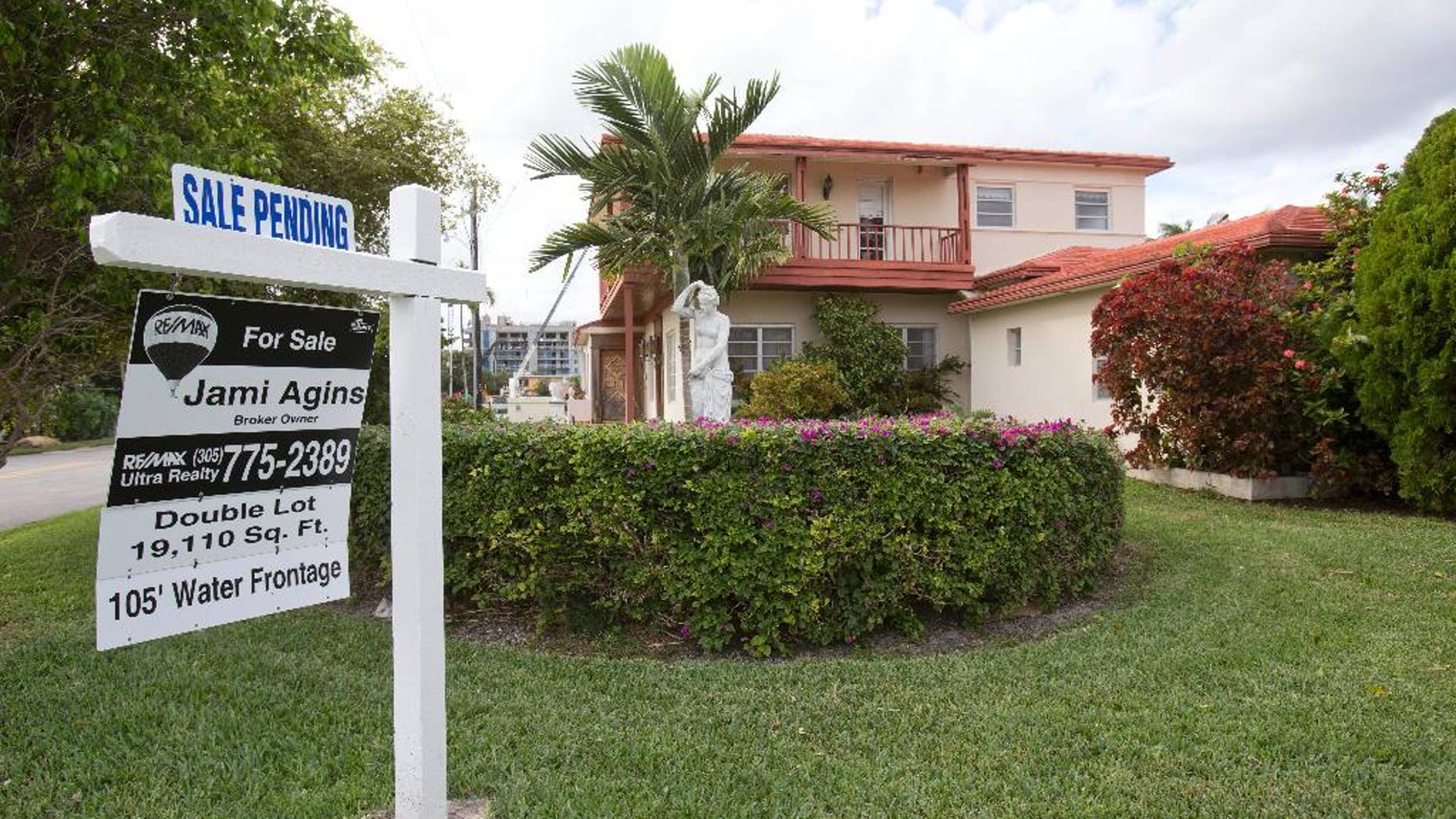 FILE - In this Thursday, Jan. 8, 2015 file photo, a "sale pending" sign is posted atop a realty sign in front of a home in Surfside, Fla. The National Association of Realtors releases its January report on pending home sales, which are seen as a barometer of future purchases, on Thursday, May 28, 2015. (AP Photo/Wilfredo Lee, File)