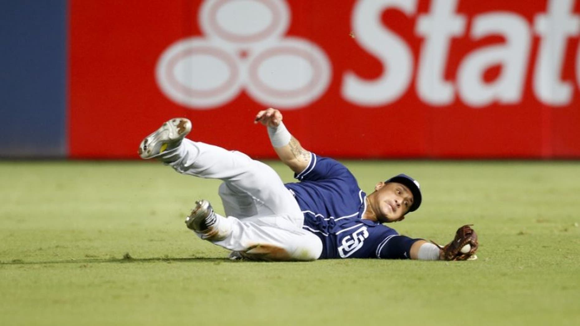 Aug 30, 2016; Atlanta, GA, USA; San Diego Padres right fielder Oswaldo Arcia (34) makes a diving catch against the Atlanta Braves in the seventh inning at Turner Field. Mandatory Credit: Brett Davis-USA TODAY Sports