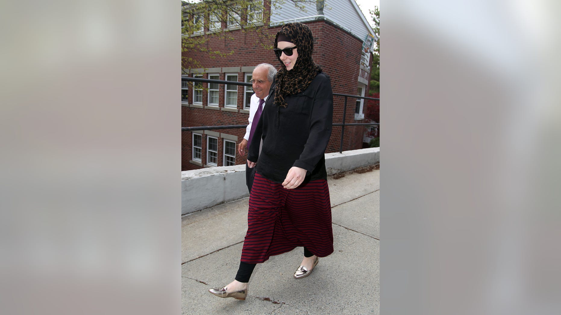 April 29, 2013: Katherine Russell, right, wife of Boston Marathon bomber suspect Tamerlan Tsarnaev, leaves the law office of DeLuca and Weizenbaum with Amato DeLuca, left in Providence, R.I.