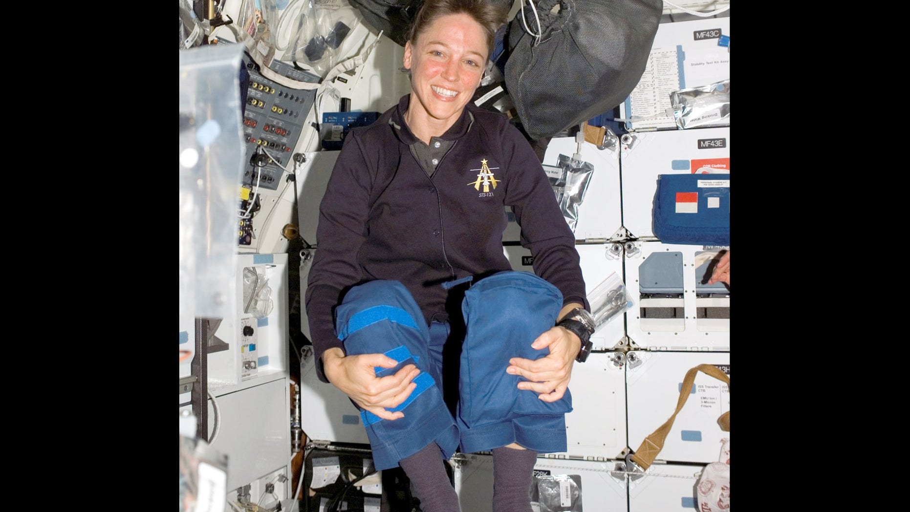 Astronaut Lisa M. Nowak, STS-121 mission specialist, floats on the middeck of the space shuttle Discovery while docked with the international space station, July 8, 2006. Nowak, 43, a married mother of three, was charged Tuesday, Feb. 6, 2007 with attempted murder, accused of hatching an extraordinary plot to kidnap Colleen Shipman, who she believed was romantically involved with another shuttle astronaut, William Oefelein. (AP Photo/NASA)