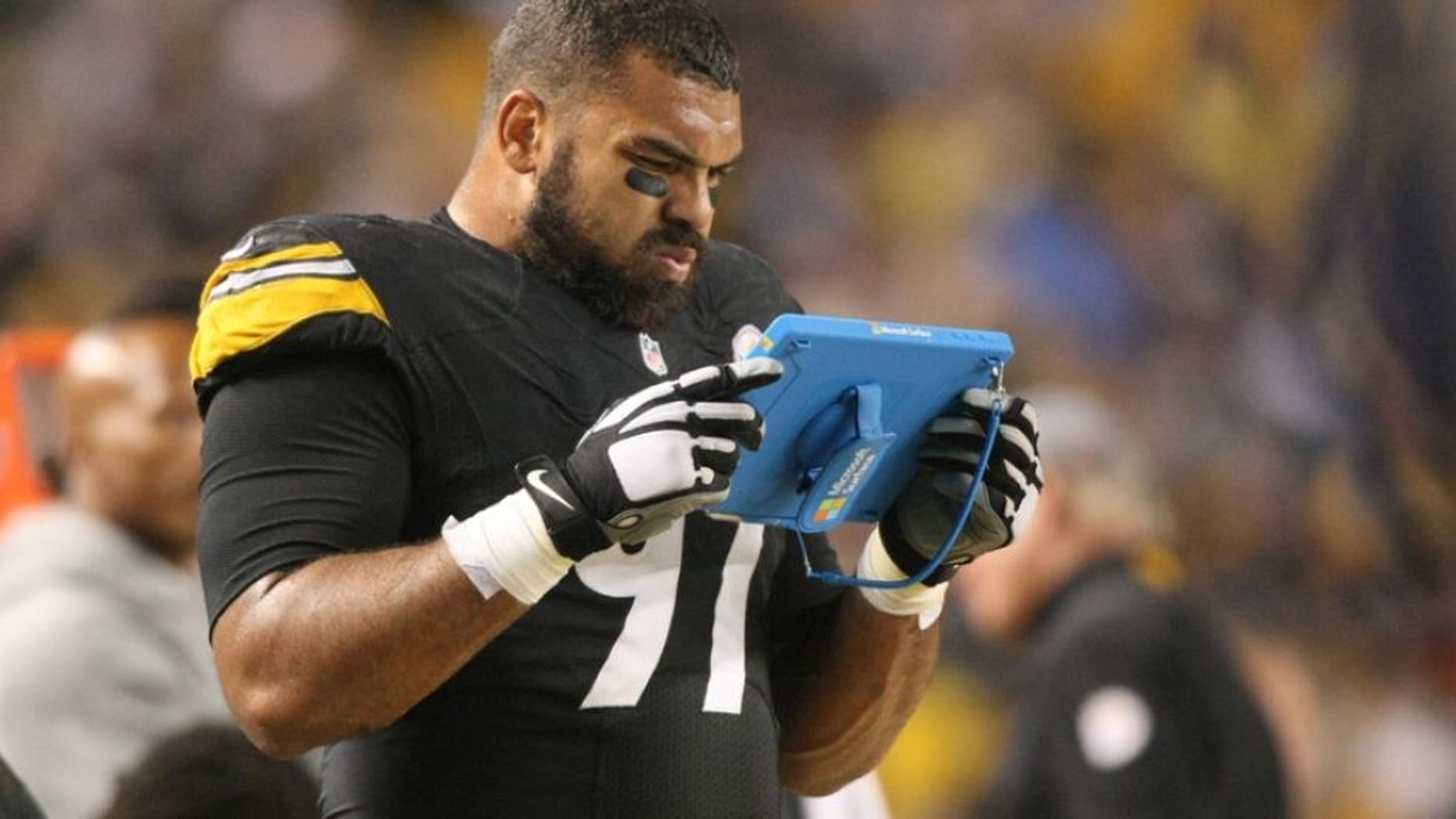 Oct 2, 2016; Pittsburgh, PA, USA; Pittsburgh Steelers defensive end Cameron Heyward (97) reviews a play on a tablet during the first half of the game against the Kansas City Chiefs at Heinz Field. Mandatory Credit: Jason Bridge-USA TODAY Sports