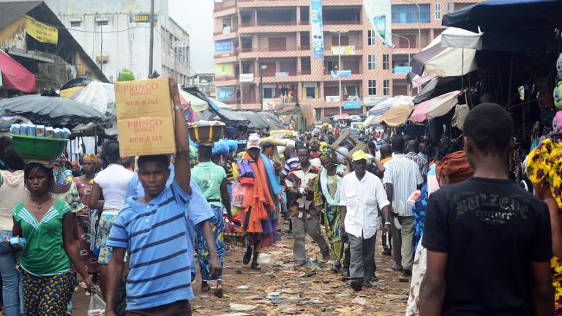 People walk in the street in Conakry on September 24, 2013.