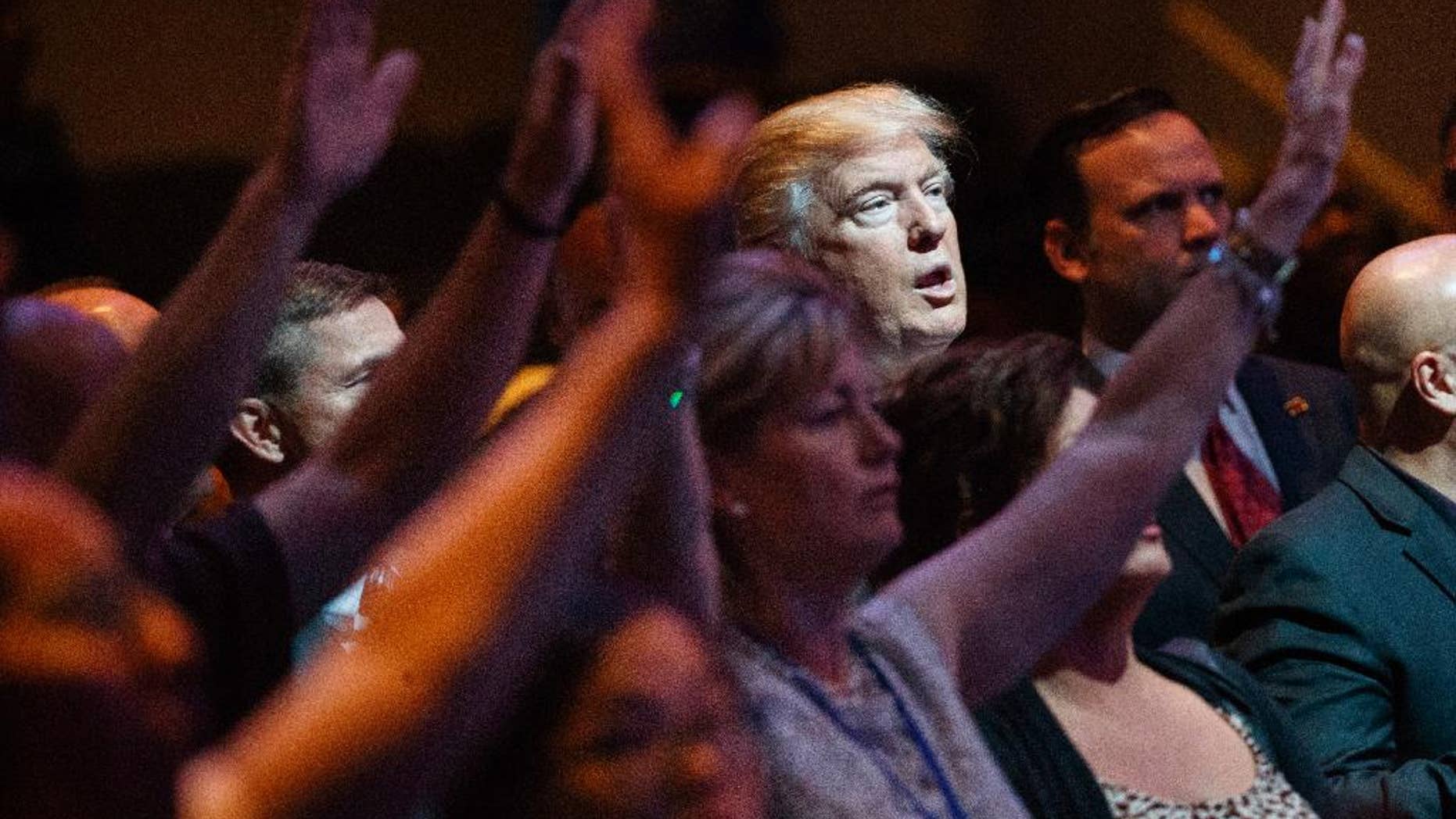 FILE- In this Oct. 30, 2016, file photo, Republican presidential candidate Donald Trump stands during a service at the International Church of Las Vegas in Las Vegas. President Trump’s pledge to scrap limits on church political activity could have sweeping effects that extend beyond his conservative supporters to more liberal congregations, including the black evangelical church that has long helped anchor the Democratic Party’s electoral machinery. (AP Photo/Evan Vucci, File)