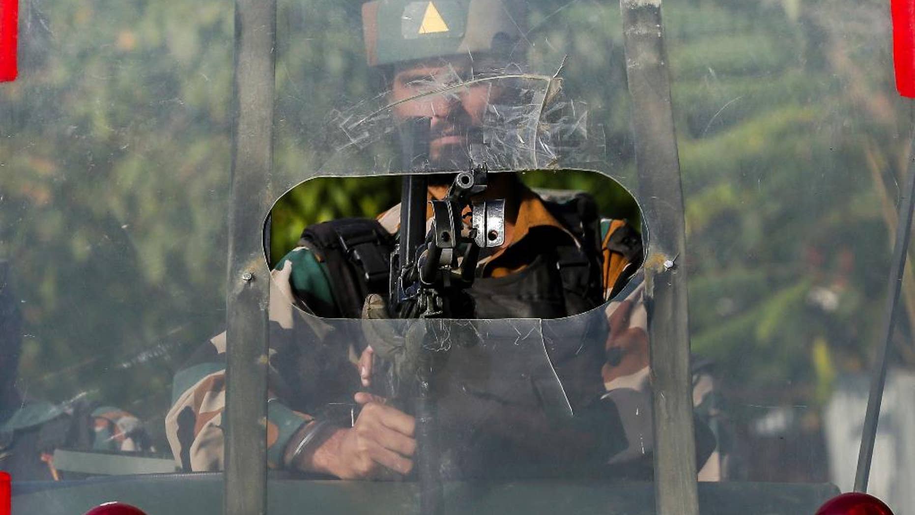 An Indian army soldier guards outside the base camp which was attacked by suspected militants at Baramulla, northwest of Srinagar, Indian controlled Kashmir, Monday, Oct. 3, 2016. A gun battle with a group of militants who attacked an Indian army camp in the Indian portion of Kashmir has ended early Monday morning, police said. (AP Photo/Mukhtar Khan)
