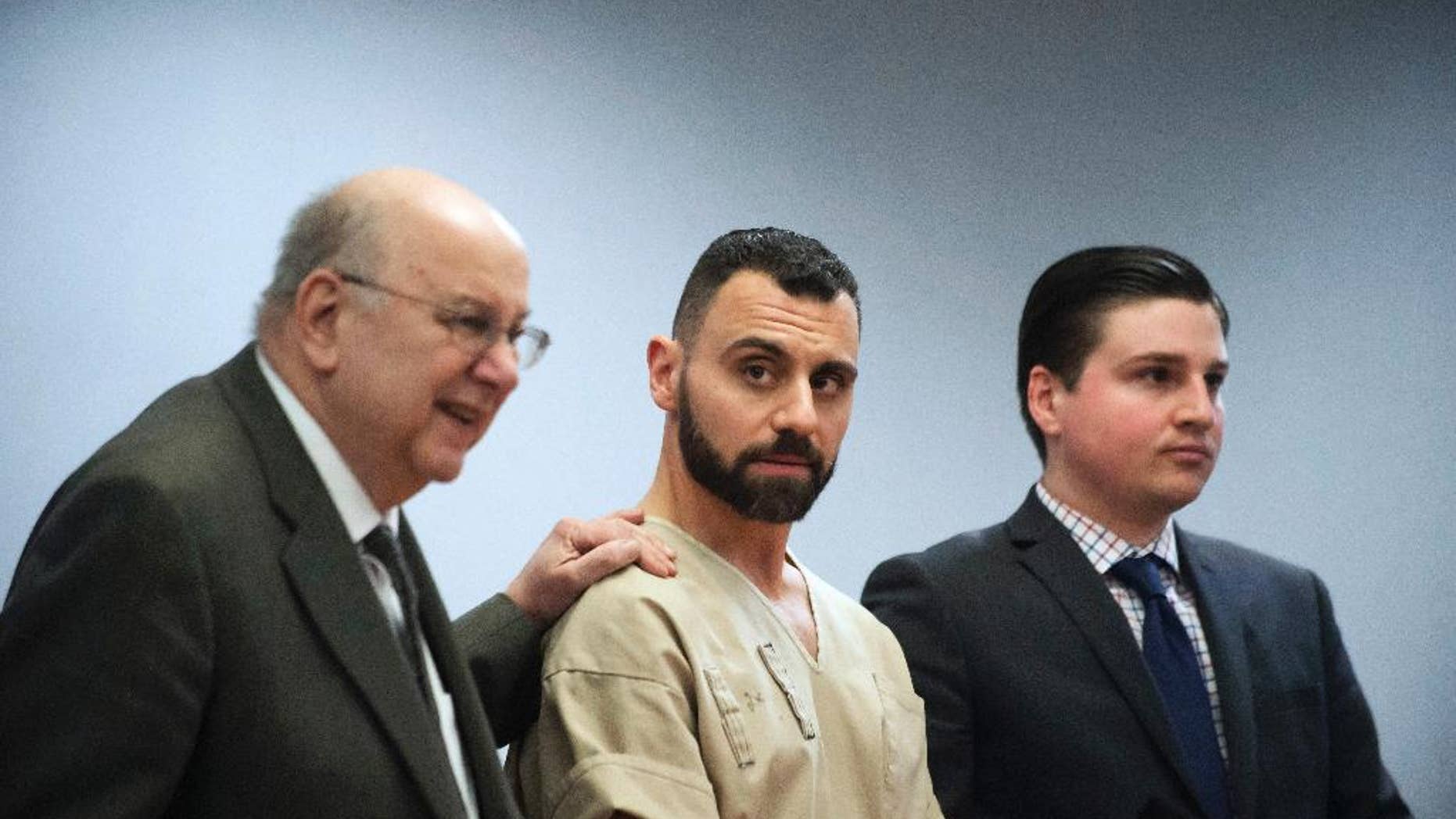 FILE - In this Monday, April 17, 2017, file photo, Richard Dabate, center, appears with attorneys Hubie Santos, left, and Trent LaLima, right, while being arraigned, in Rockville Superior Court in Vernon, Conn. Authorities said Dabate told them a masked man had entered their home Dec. 23, 2015, shot his wife and tied him up before he burned the intruder with a torch. But the New York Daily News reported the Connecticut State Police wrote in an arrest warrant that his wife’s Fitbit was logging steps after the time Dabate told them she was killed. (Mark Mirko/Hartford Courant via AP, Pool, File)
