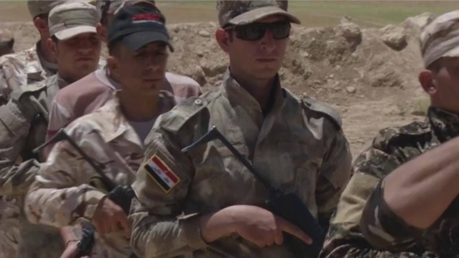 In this video grab made on Tuesday, June 14, 2016, in Alqoosh, Iraq, shows Assyrian Christian militiamen during a training. The group also know as the Nineveh Plain Protection Units, or NPU, are one of three Christian armed groups who are hoping for American support after the U.S. House of Representatives called for direct assistance to be delivered to local security forces in the north of Iraq. (AP Photo/ Balint Szlanko)